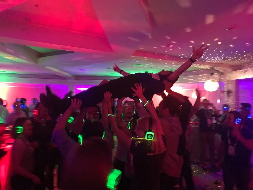 participants dance in a colourfully-lit space