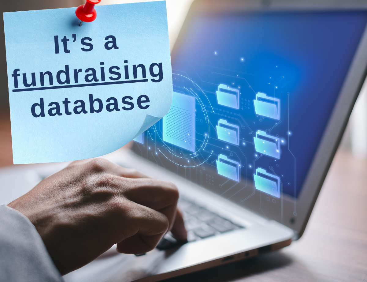 Text that reads It's a fundraising database on a post-it note over a computer with someone typing
