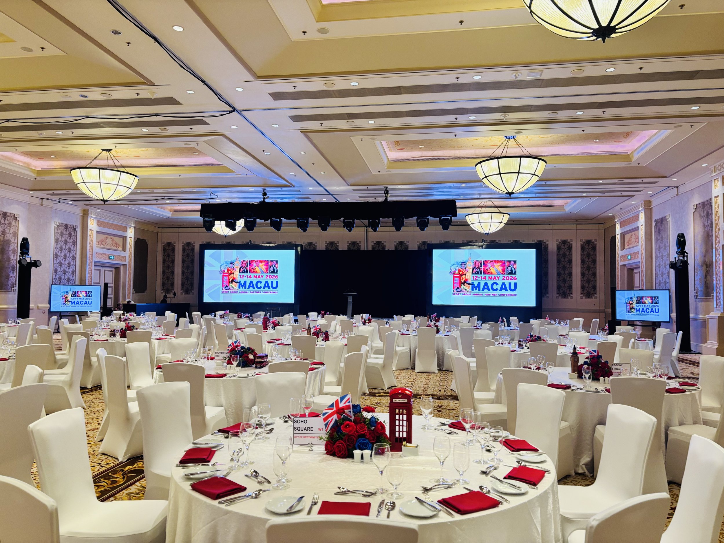 Full venue styling for Sport Group Annual Partner Conference with bespoke centrepieces, stage and event entrance installation