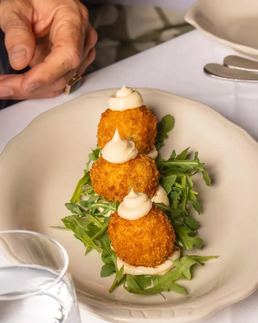 A warm welcome starts here 💛
Crispy prawn arancini and a glass of something good.