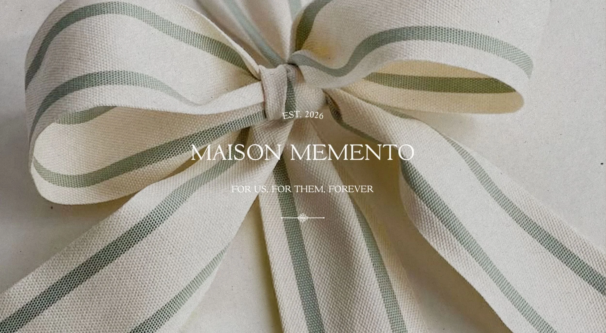 Maison Memento luxury album design featuring gold foil logo branding on a textured linen cover.