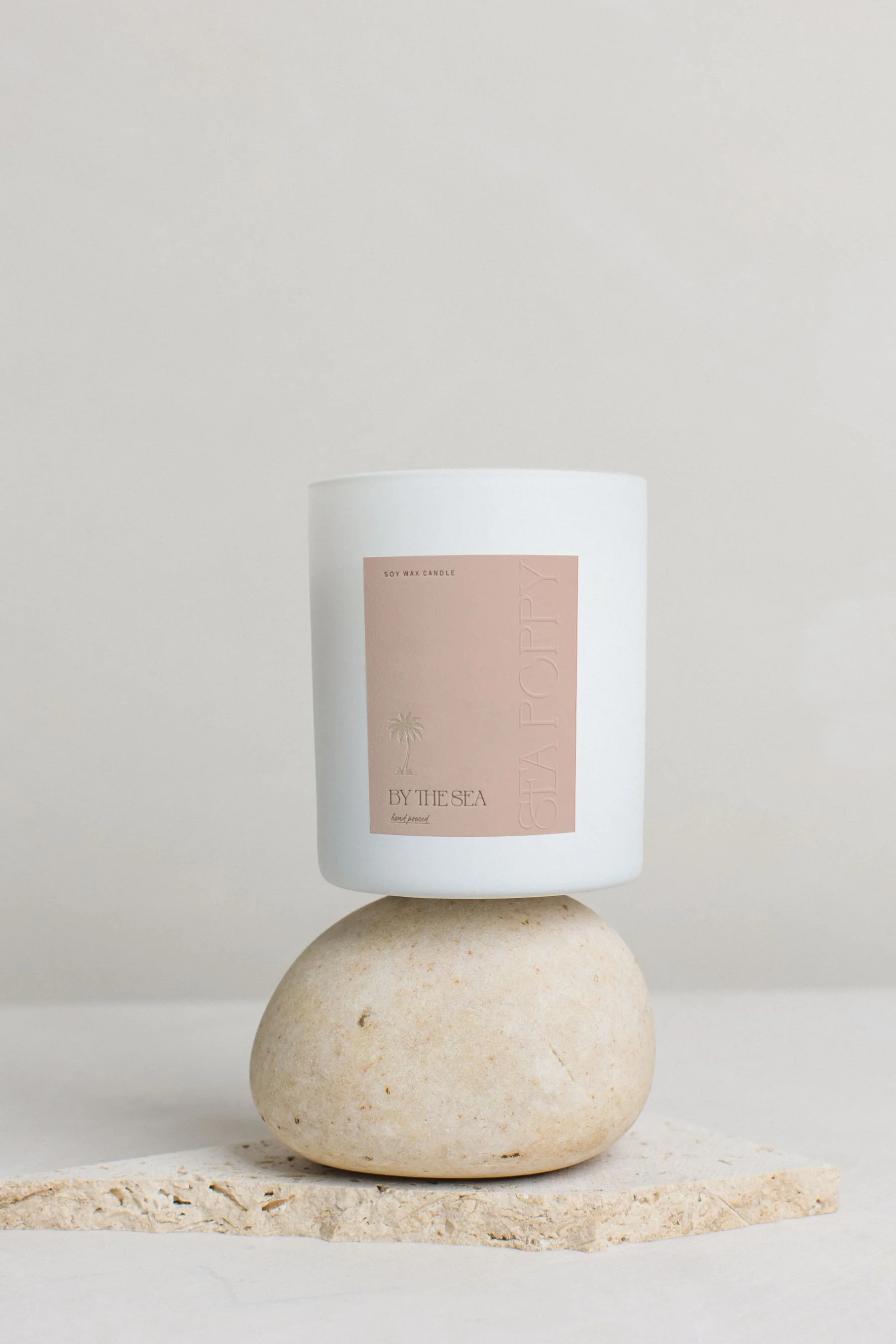 candle jar mockup of label with embossing and gold palm for sea poppy studio candle business