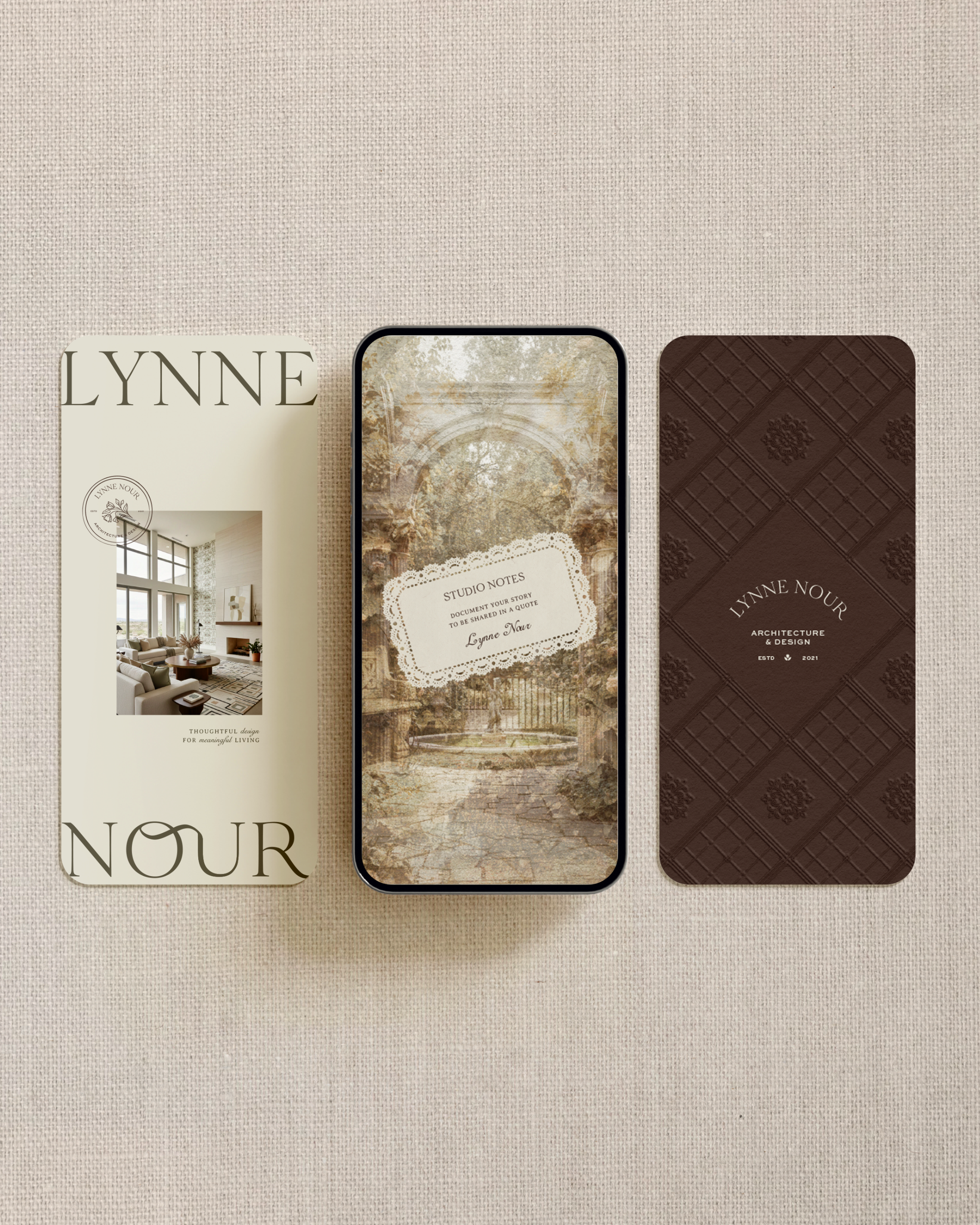 A smartphone displaying a decorative background with trees and arches, surrounded by two booklet covers titled 'Lynne Nour' and 'Architecture & Design'.