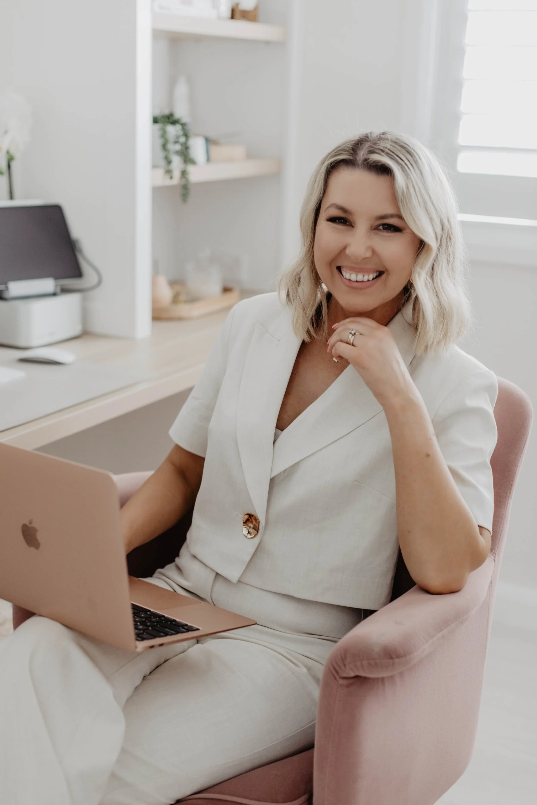 Sandra Morris - Brand & Website designer, Sunday Lane Studio. Based in Wollongong, Australia, designing for brands all over the world. Entrepreneur smiling brand photography photoshoot, home office studio with macbook