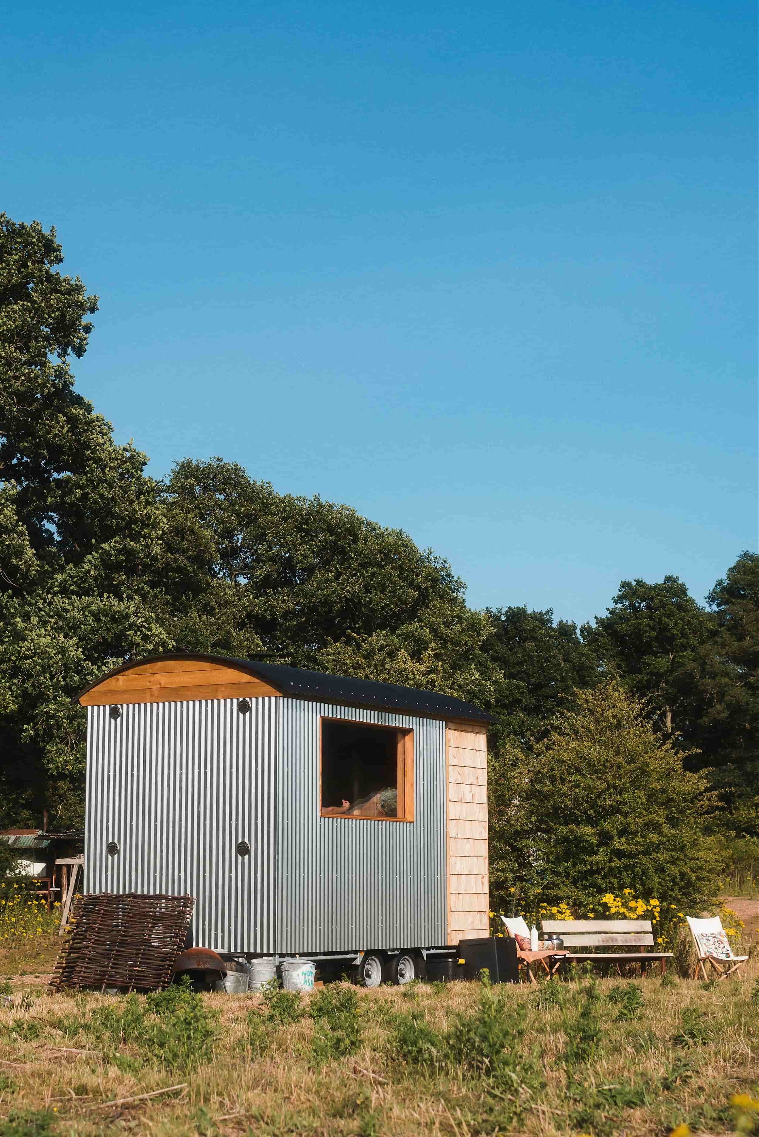 A beautiful sunny day with a blue sky and a horsebox sauna