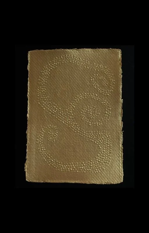 A gold-colored textured surface with an embossed gold dollar sign.