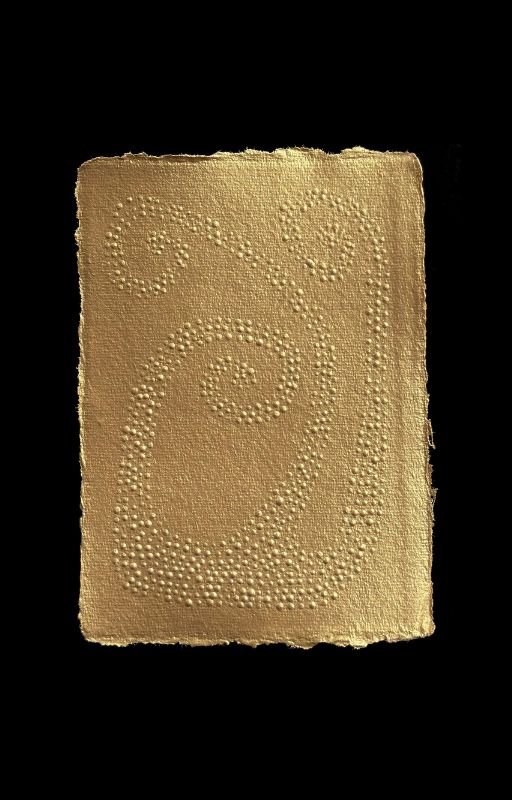 An embossed cereal bar with a decorative swirl pattern on a black background.