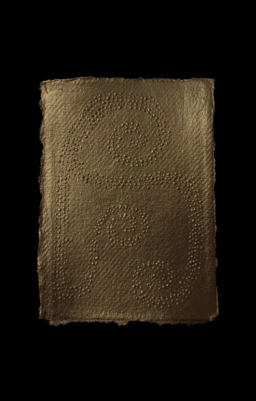 A textured chocolate bar with an embossed swirl pattern on a black background.