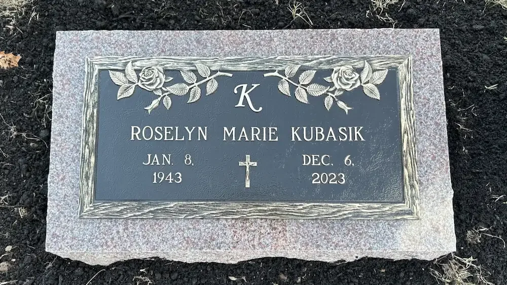 Bronze plaque headstone affixed to granite base