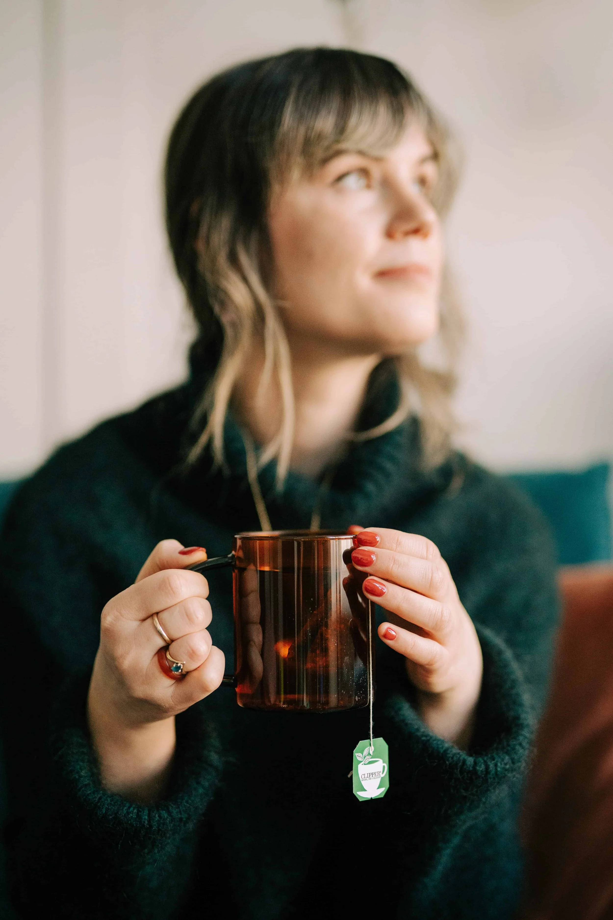Alice from slide shades in Liverpool, enjoying a hot tea whilst looking out to the window
