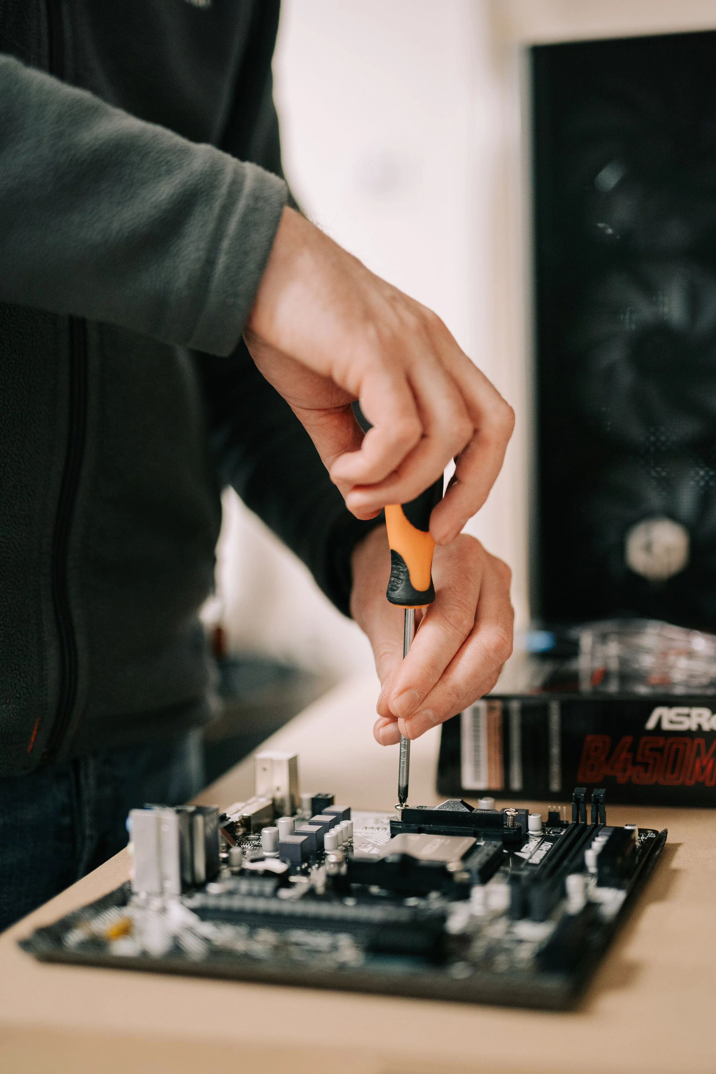 technician at mels comuter care holding a screwdriver building a computer