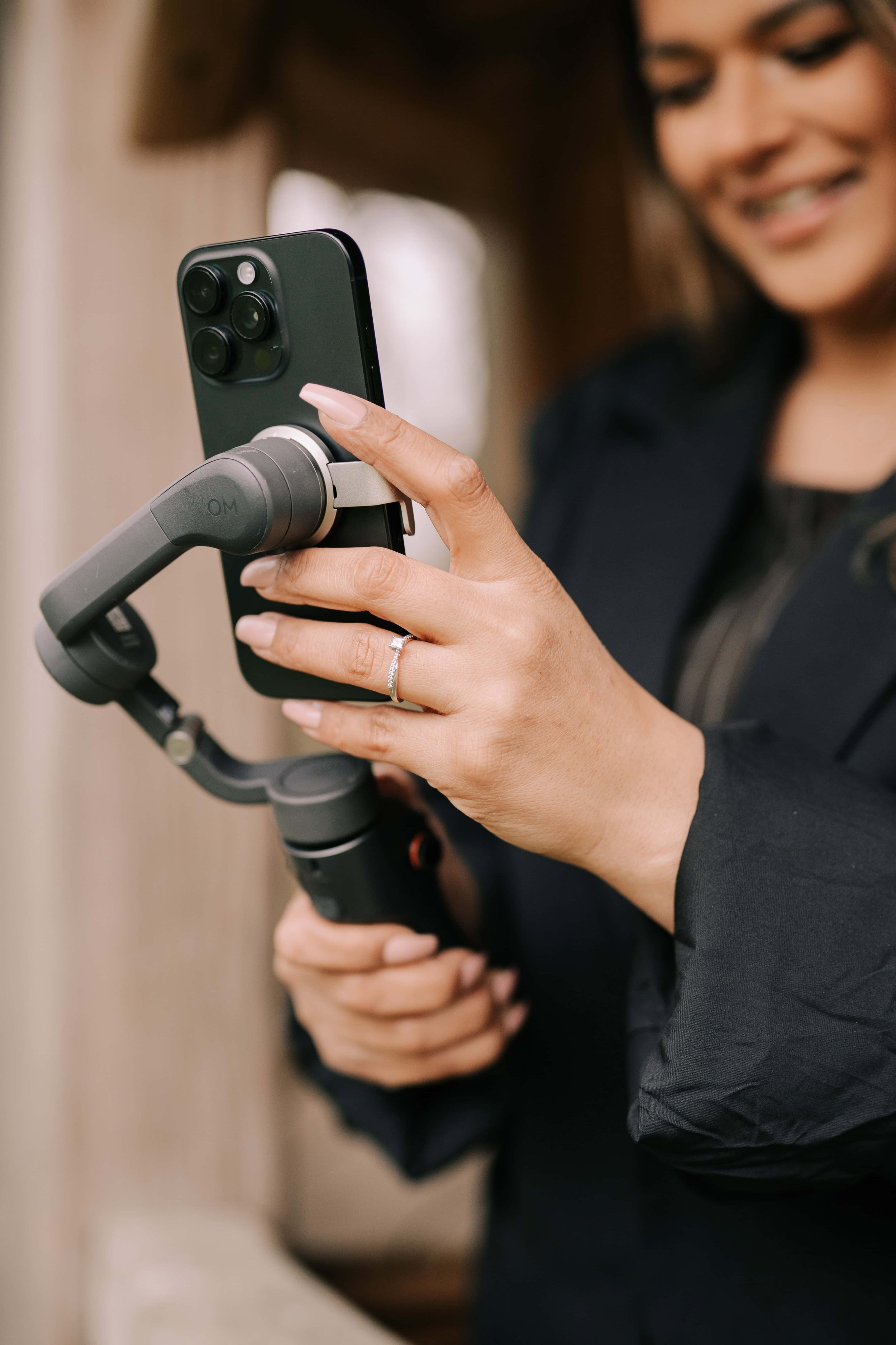 content creator had her mobile phone in a gimbal, the photo is focusing on her hands whilst she is tapping her phone