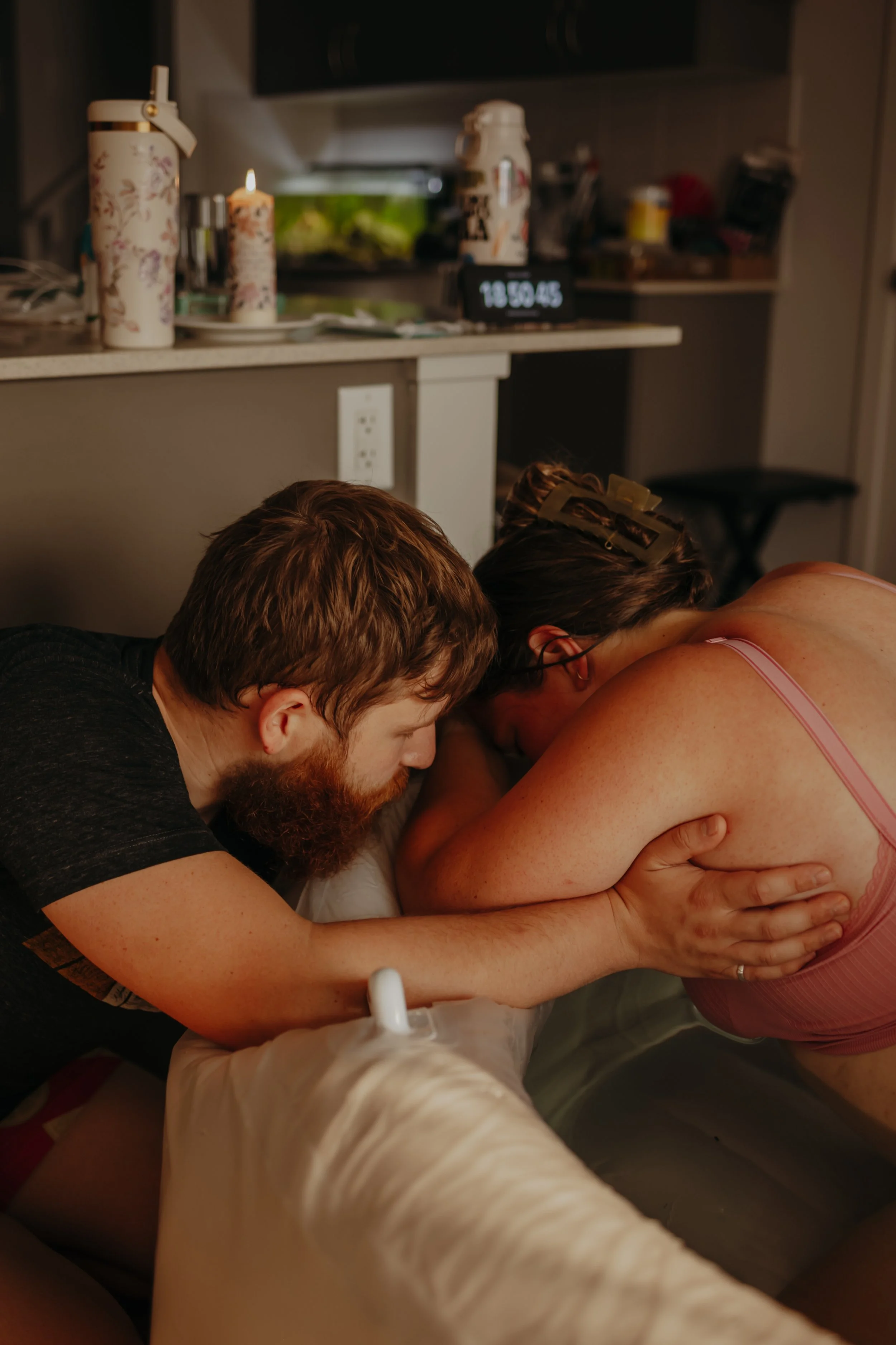 Alex, our owner, in labor with her 3rd baby, at home with her husband in our beautiful white birth pools that we rent!