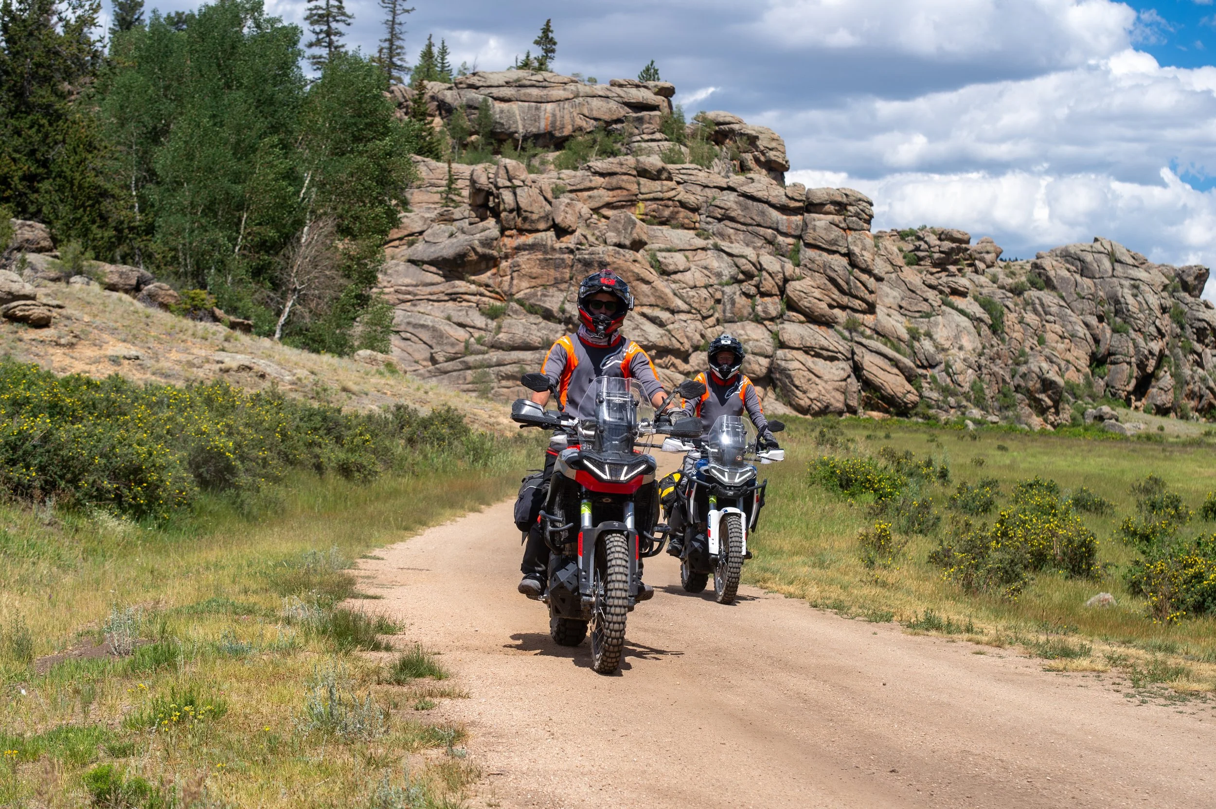 4 Mile - riders coming to a curve in 4 mile with rocks behind.jpg