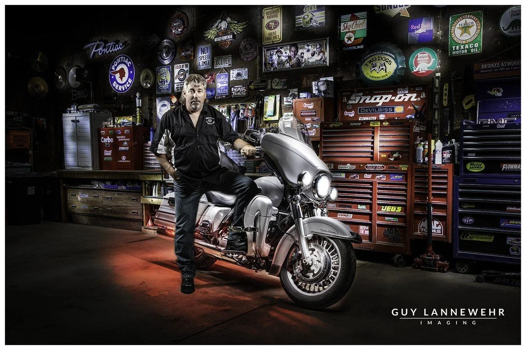 Working on doing some &quot;Painting with Light&quot; techniques I've been bragging about. This is my buddy Mike and his Harley we photographed in his garage over the weekend. Really wanted to showcase all of his collection of signs on the back wall,