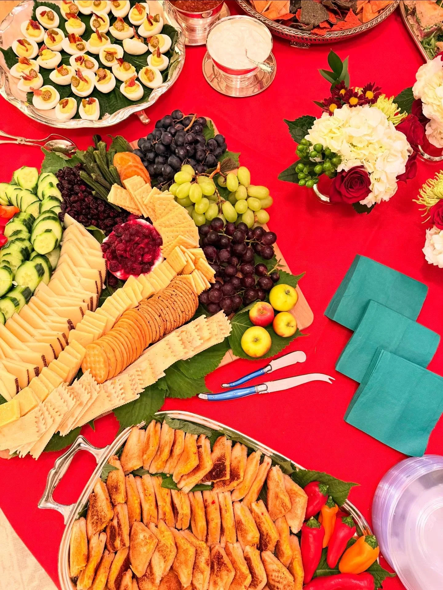 Cocktail supper buffet view from above&hellip;Spinach and Artichoke dip with salsa and sour cream, grilled pimento cheese triangles and deviled eggs with pickled okra and crispy bacon.  Merry Merry!