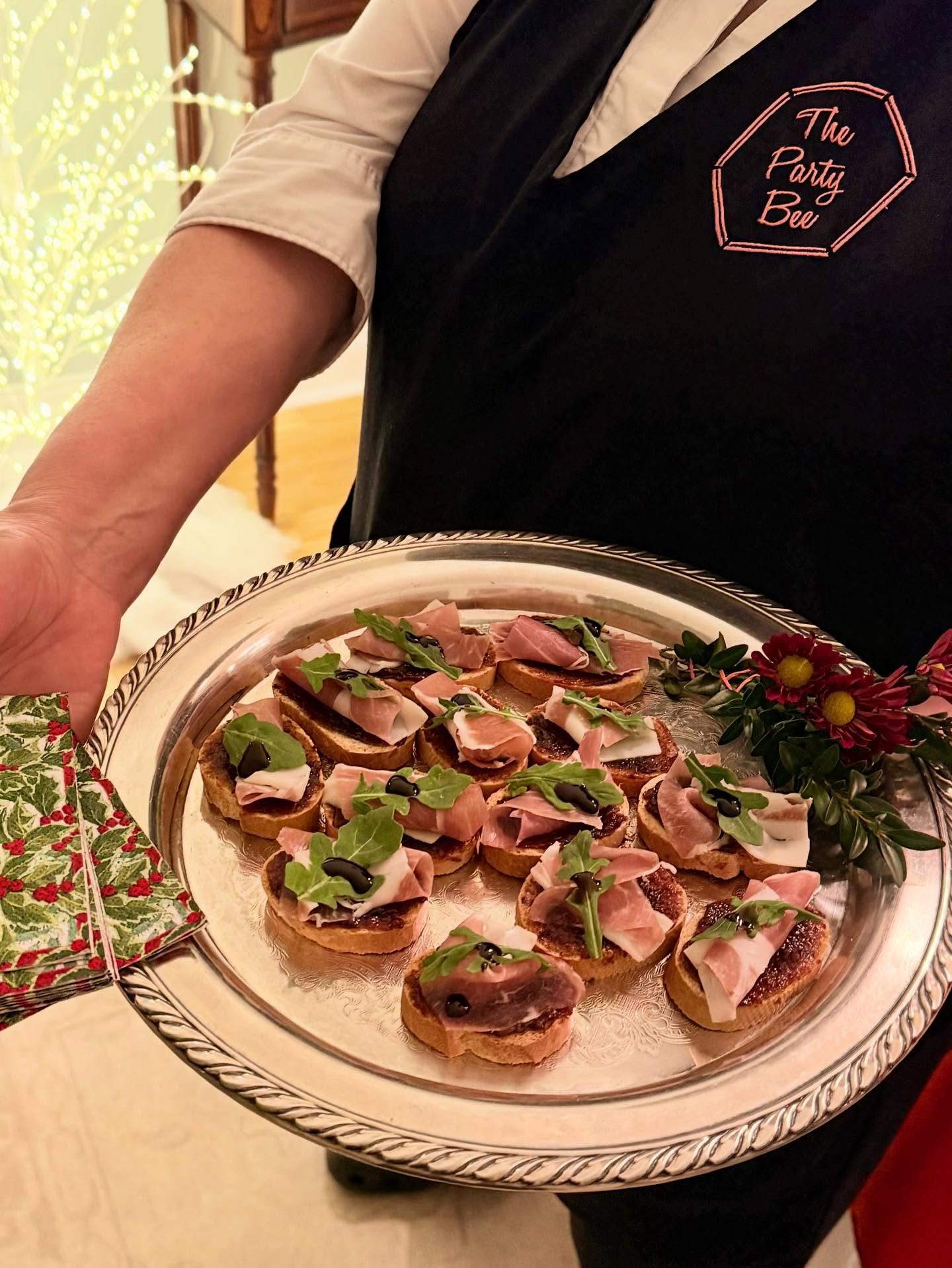 Party Bee Crostini with fig butter, prosciutto, and arugula passed on a silver platter