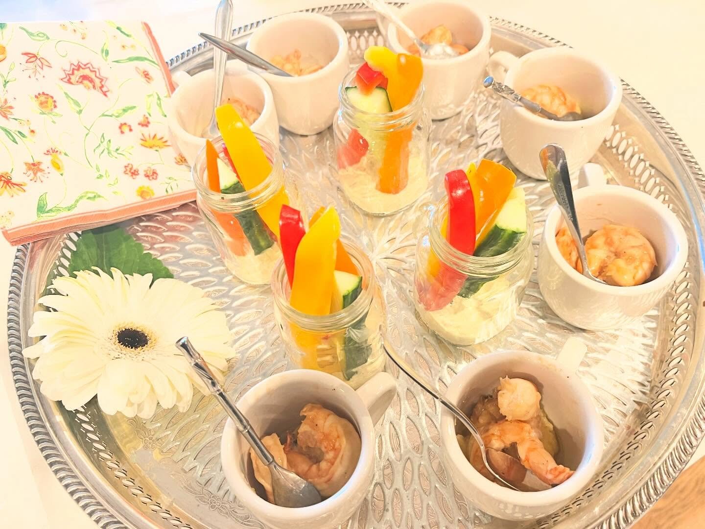Passing a platter of two party favorites: a demi tasse of shrimp and grits and a veggie cup with curry cucumber dip. Sometimes even when there is a buffet it&rsquo;s nice to meander though the guests with an &ldquo;advertised pass&rdquo; of what is o