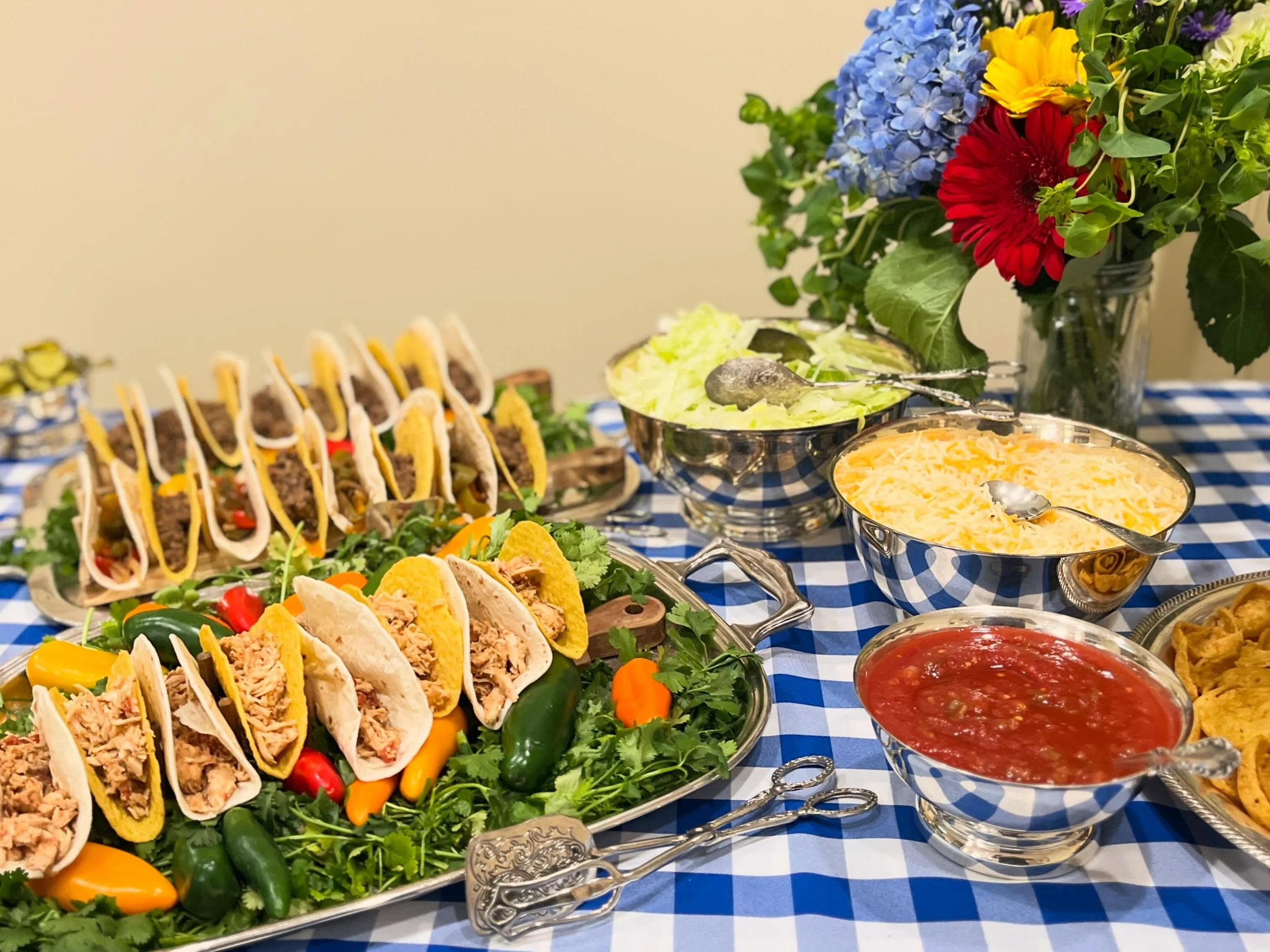 Tacos and bbq sliders at a corporate reception.  Since it was near Cinco de Mayo we used casual linens and bright colors to carry the theme and give the guests a taste of home.