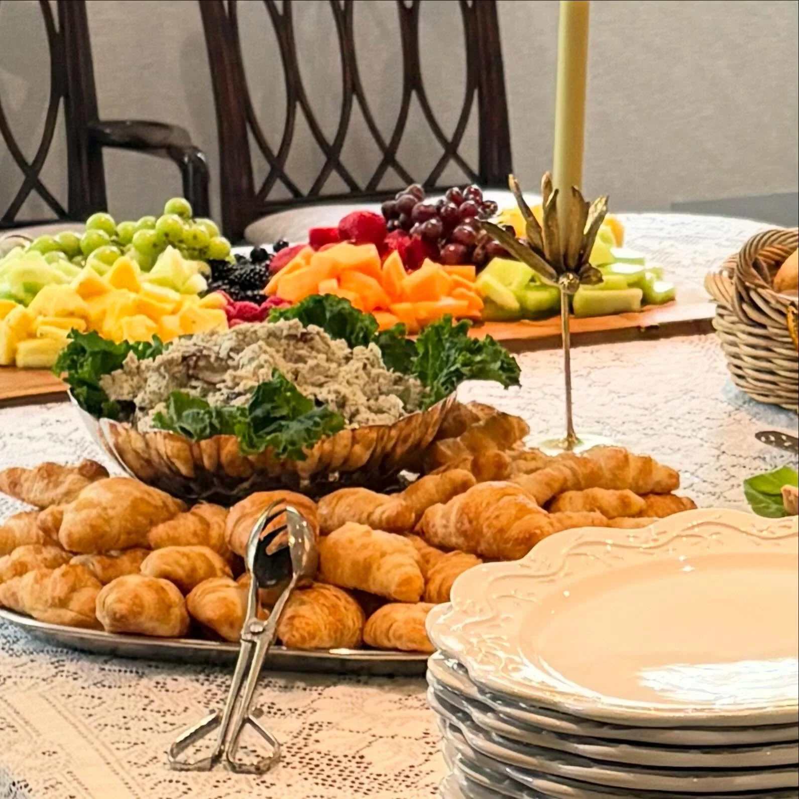 A brunch buffet with chicken salad, mini croissants, a fruit board and breakfast breads and muffins. At the other end of the buffet we offered roasted salmon with cucumber dill sauce and a marinated vegetable salad.
