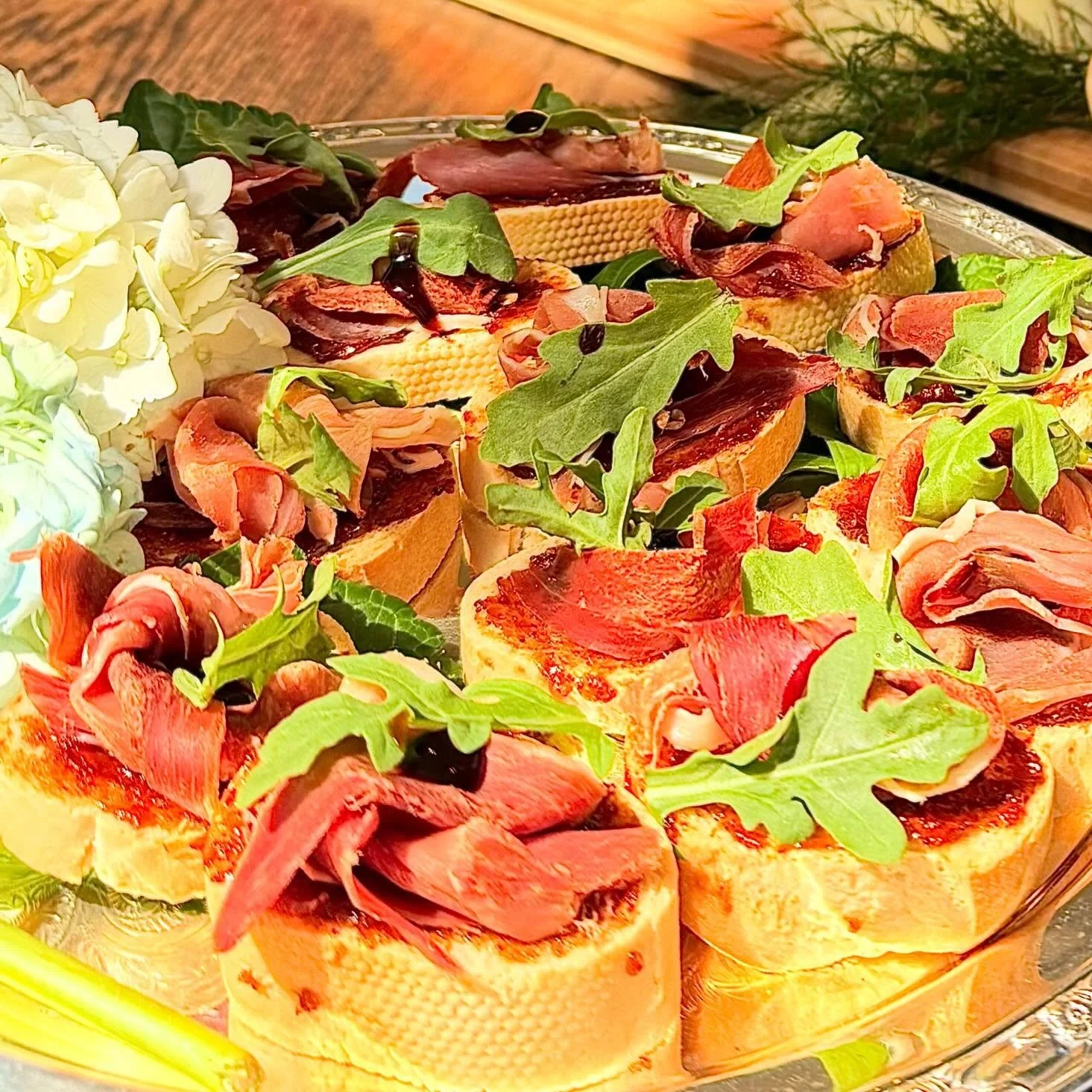Our &ldquo;Party Bee Crostini&rdquo; has been a hit for over a decade- all my favorite flavors: sweet figs, salty prosciutto, peppery arugula and a drizzle of balsamic glaze. Yum, yum, yum!