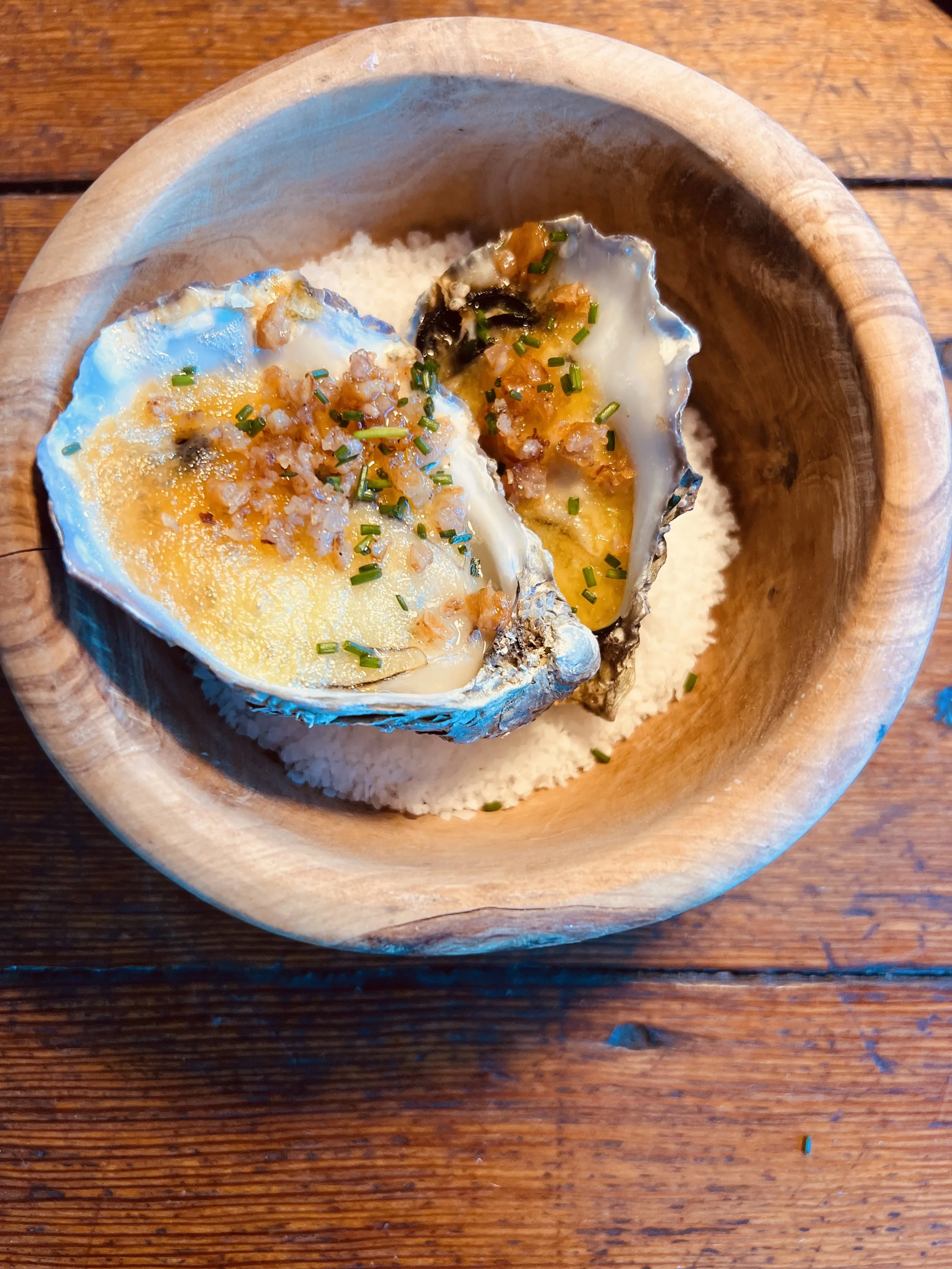 Broiled Oysters with Hollandaise, crispy chicken skin and chives.