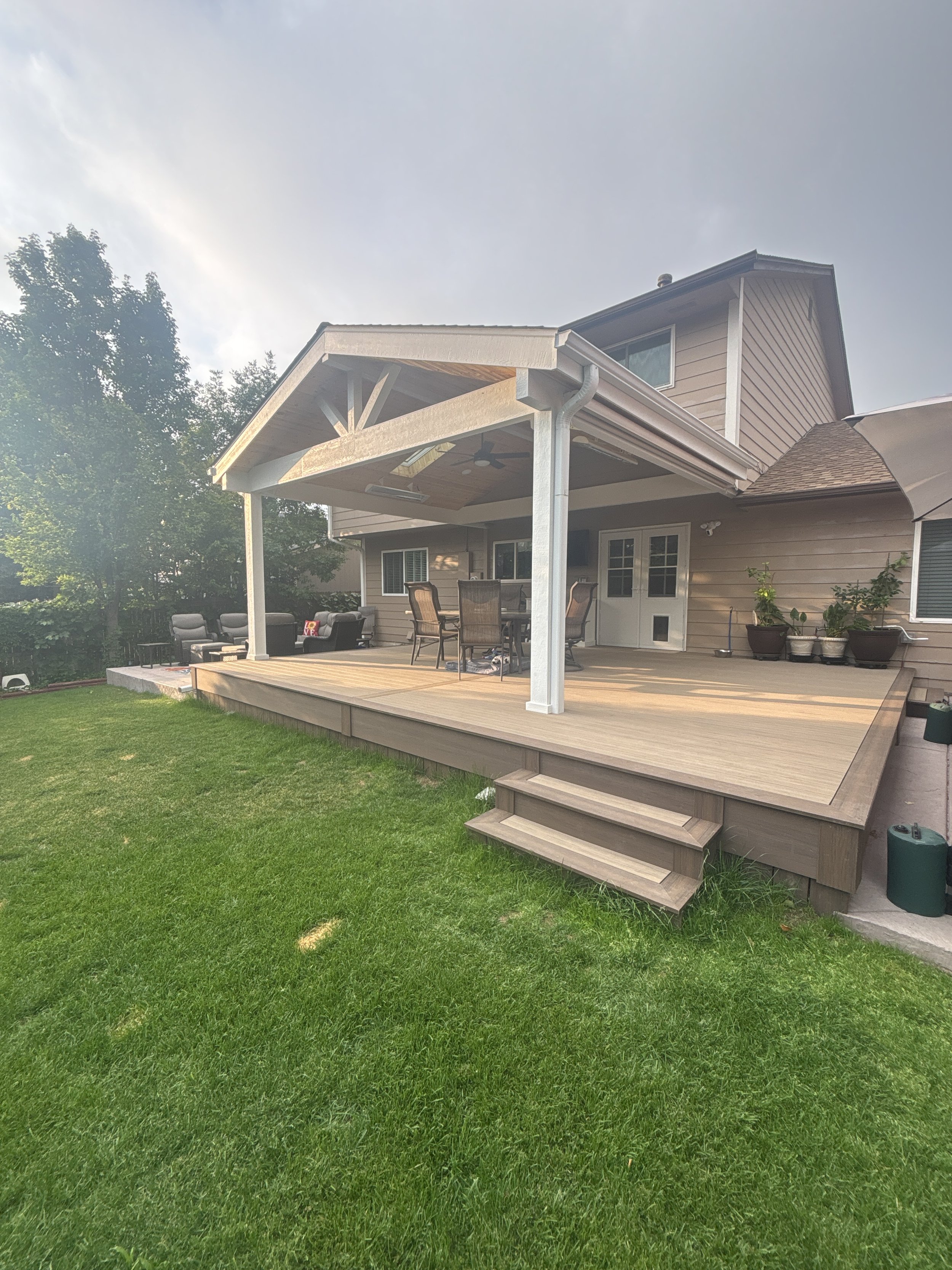 Gable roof patio cover with exposed truss over a composite deck, Colorado