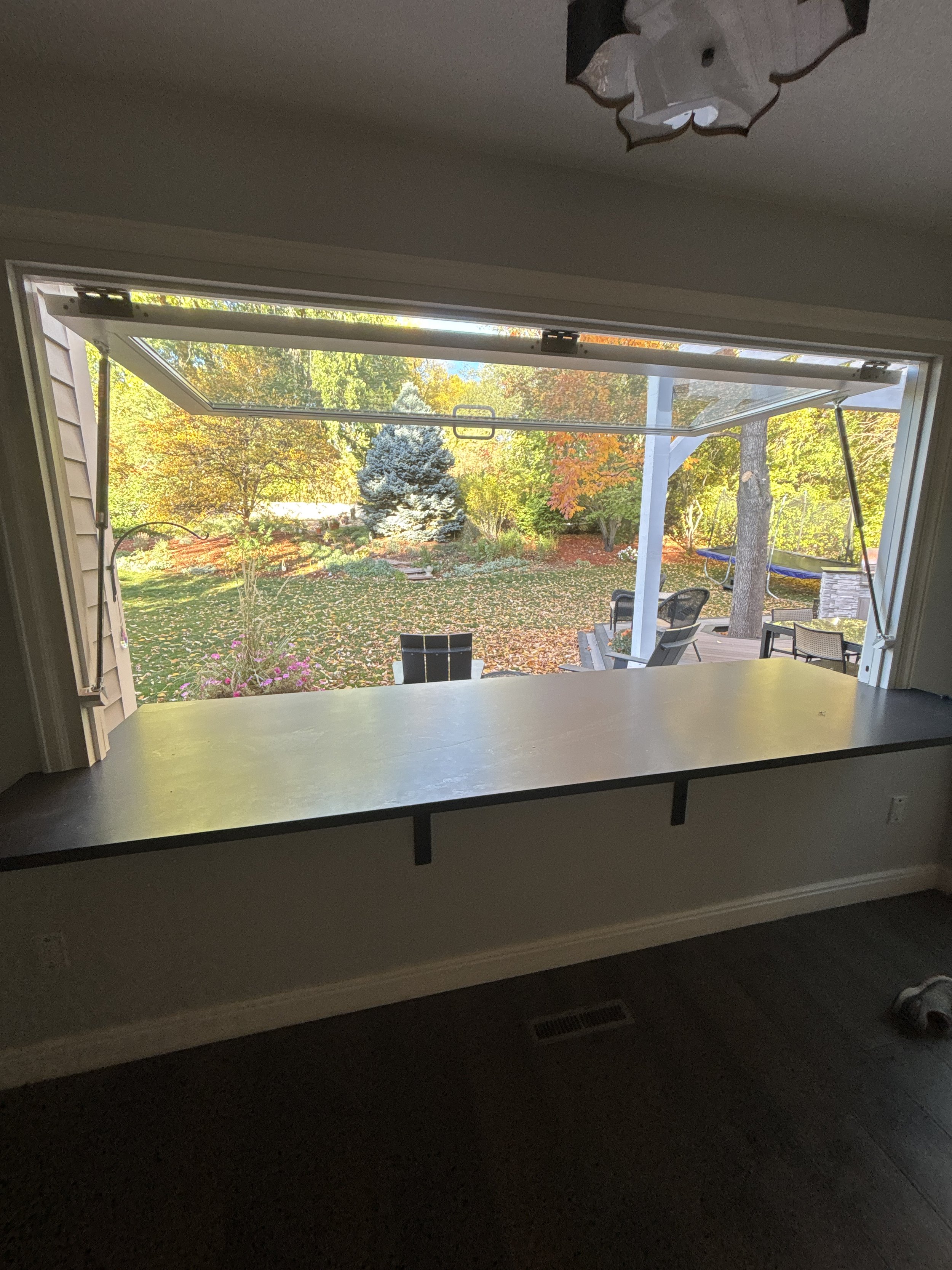 Pass-through serving window connecting the indoor kitchen to the deck