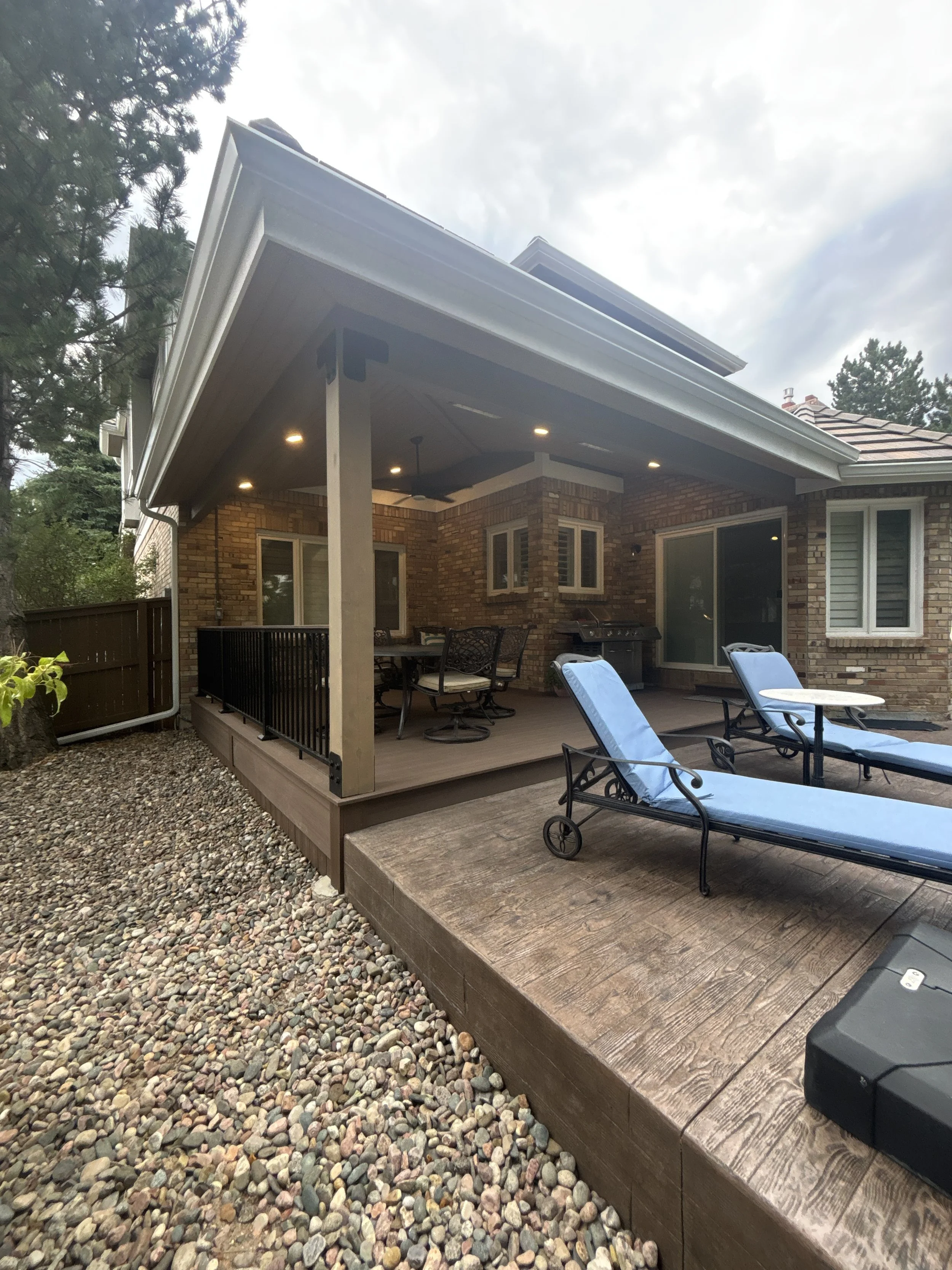 Hip roof covered deck with a tile roof at a Highlands Ranch, Colorado home