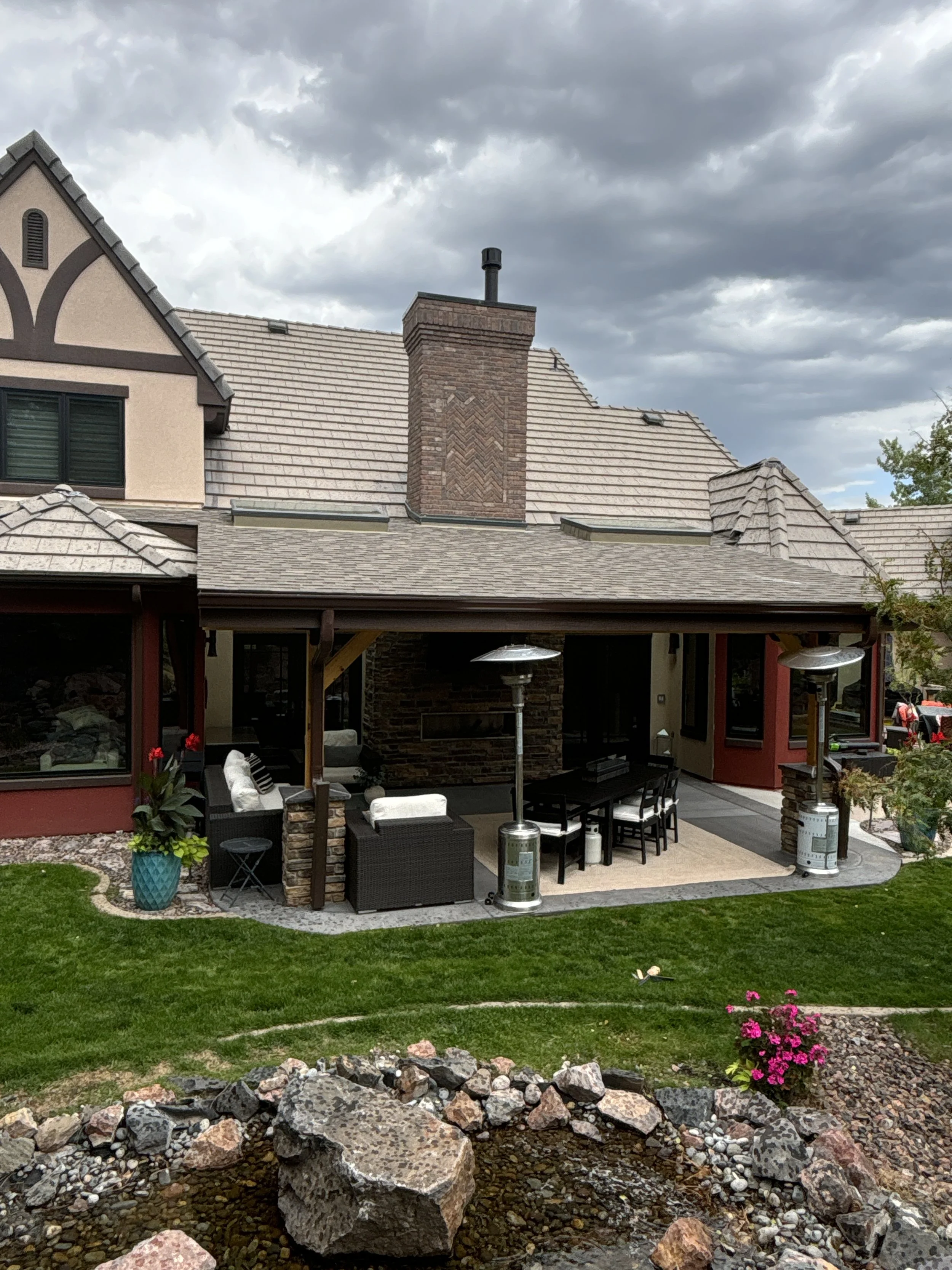 Shed style patio cover with a single sloped roof attached to a Colorado home