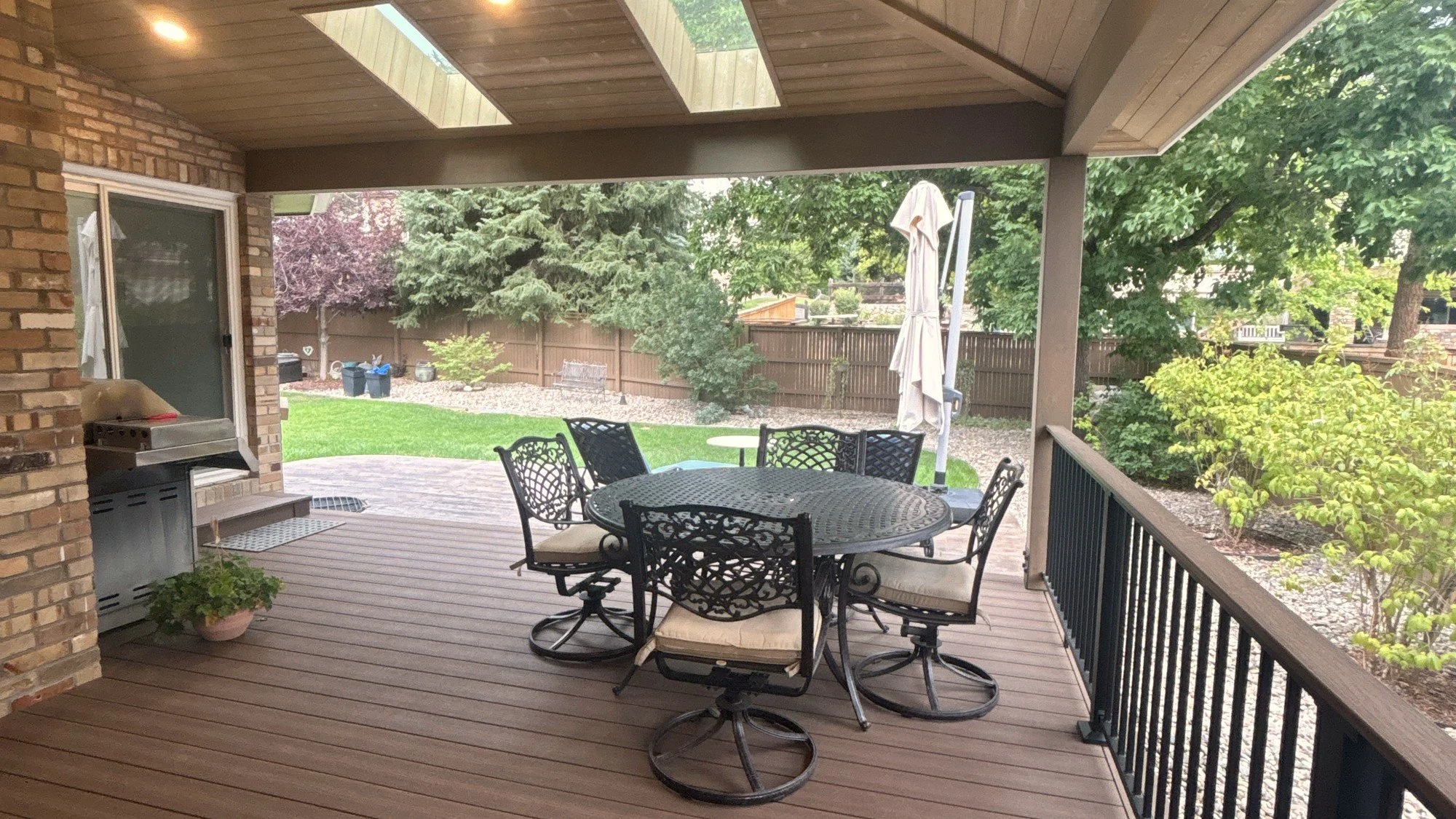 Dining area under a patio cover with a wood ceiling at a Colorado home