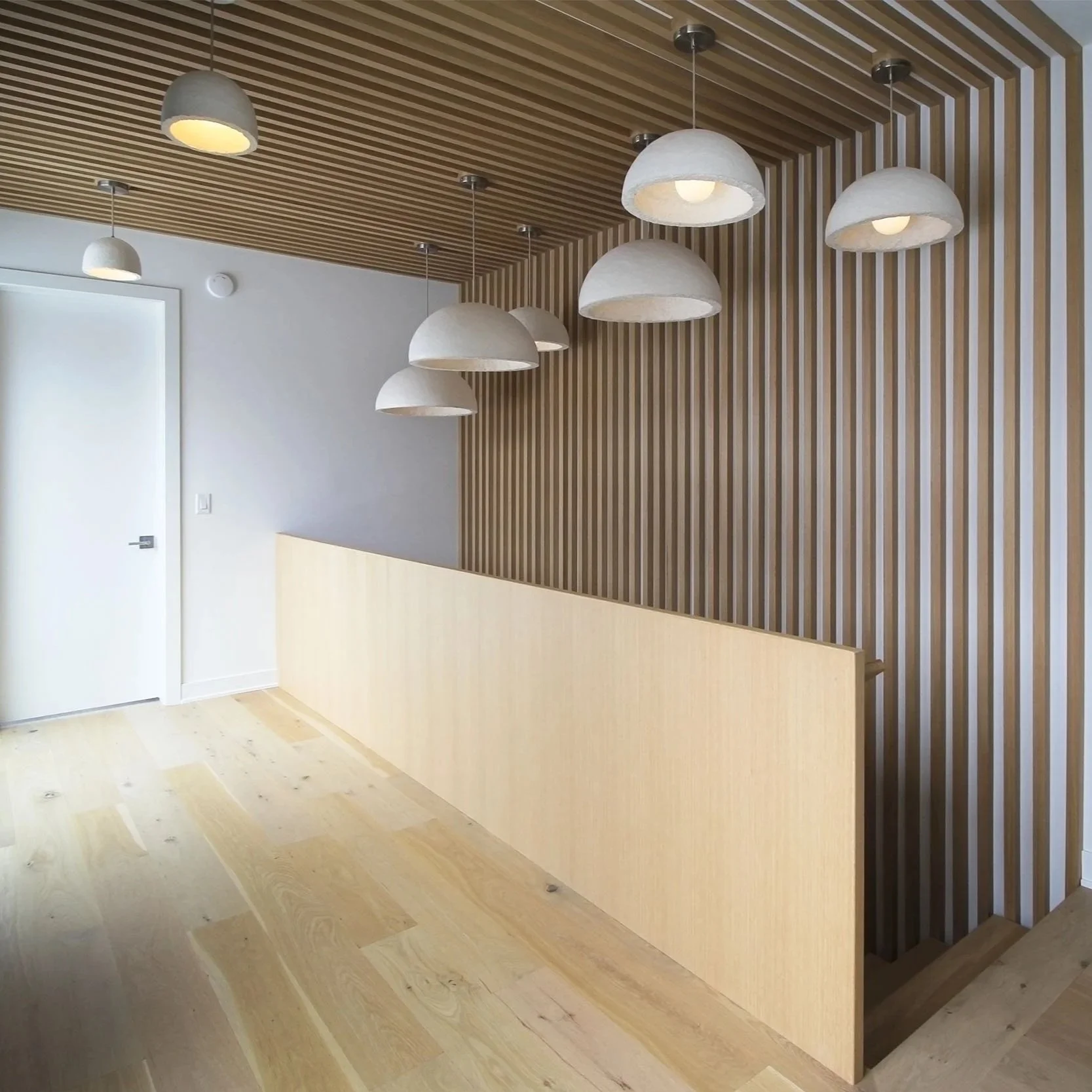 mycelium lamps hanging in residential hallway in staircase