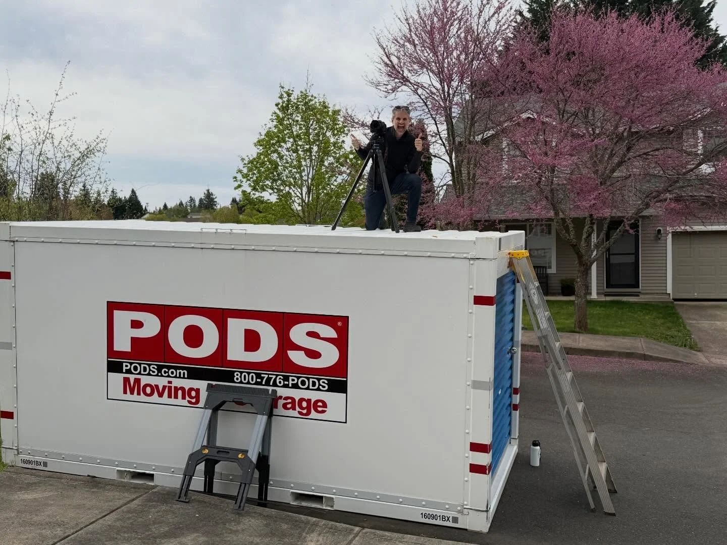 When the moving Pod is placed directly in front of the house, I just use it for a different perspective for the front exterior photos. And, through the use of creative angles and compositions, none of the photos I capture will include the Pod. 

I do