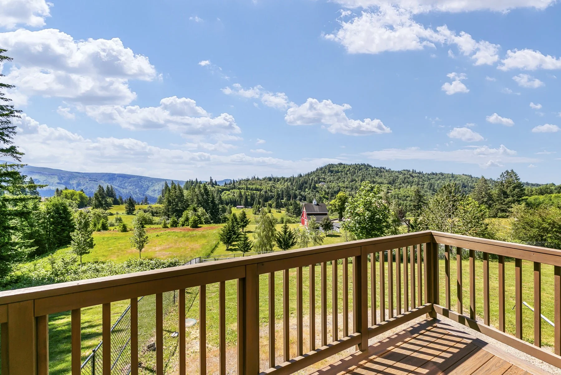 Scenic view of the Columbia River Gorge area from the back deck of a lodge-style home in Washougal, WA that was photographed by Paul Rich Studio