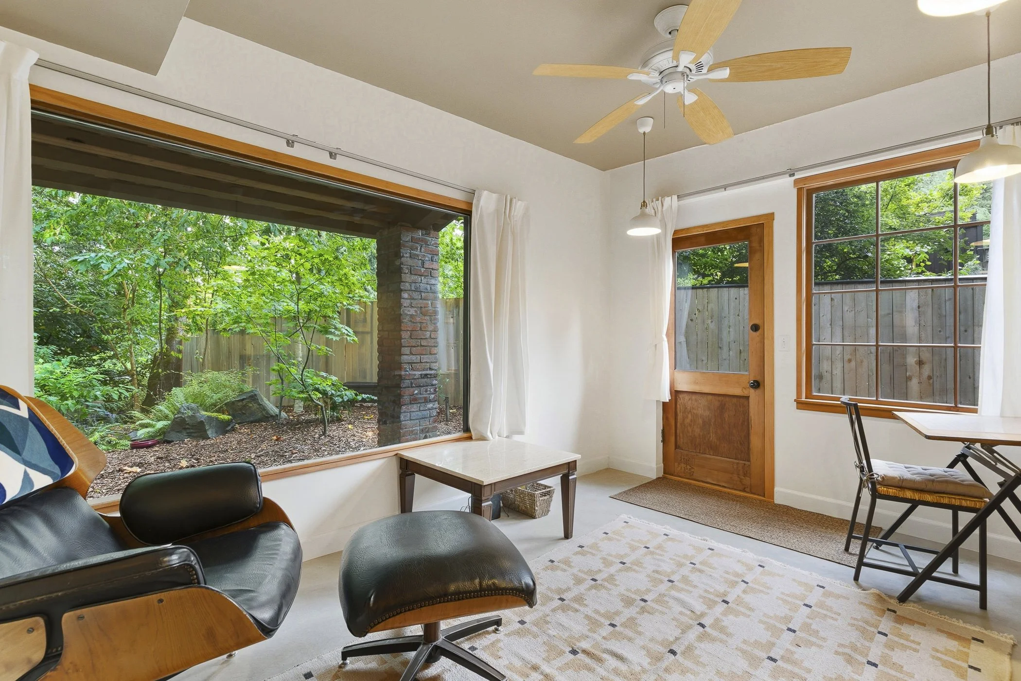 Private reading and work space area in SW Portland with a scenic view of lush greenery through the oversized window