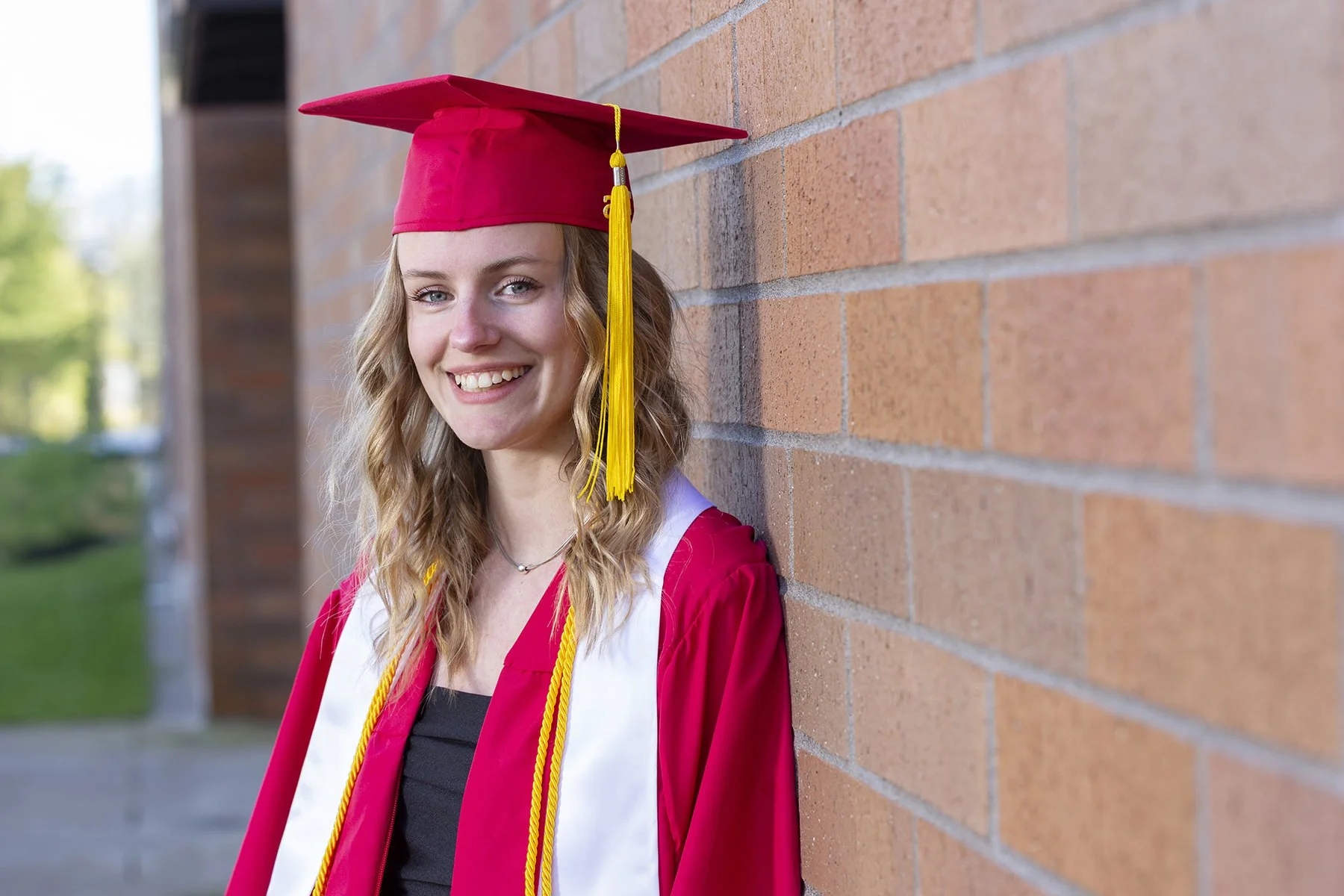 Western Oregon University graduate smiling for a portrait by Paul Rich Studio