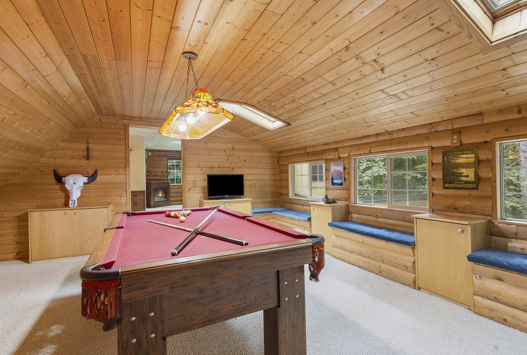 Entertainment Room with a pool table in a rustic cabin in Northwoods