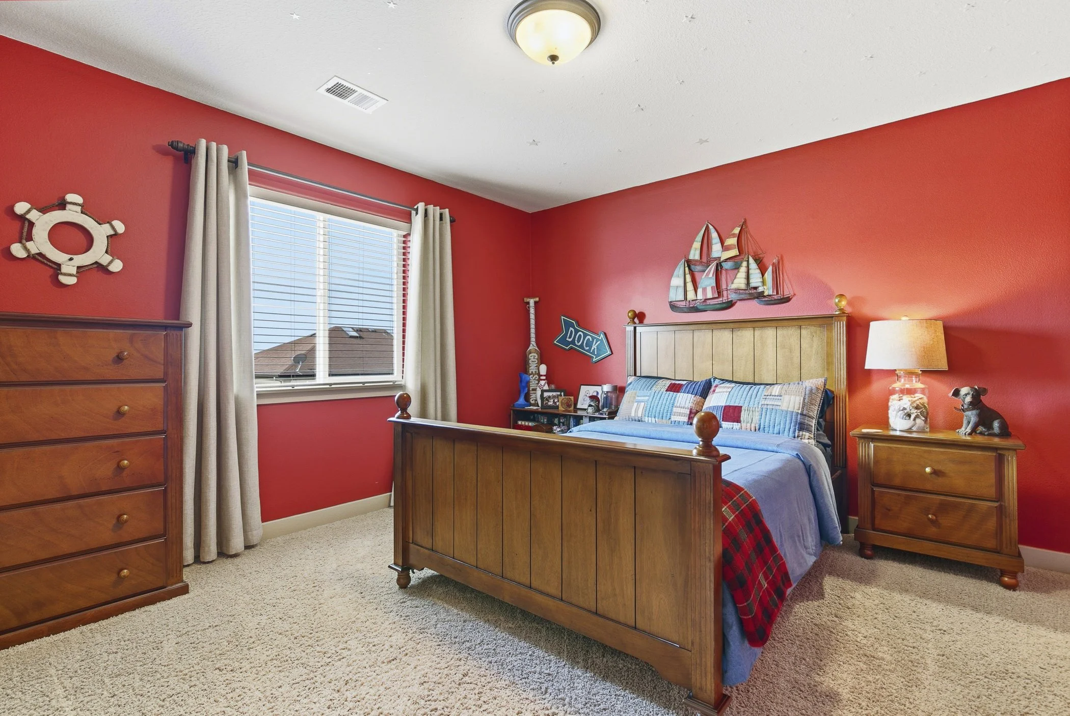 Spacious bedroom with a bright red wall color and nice details and decor