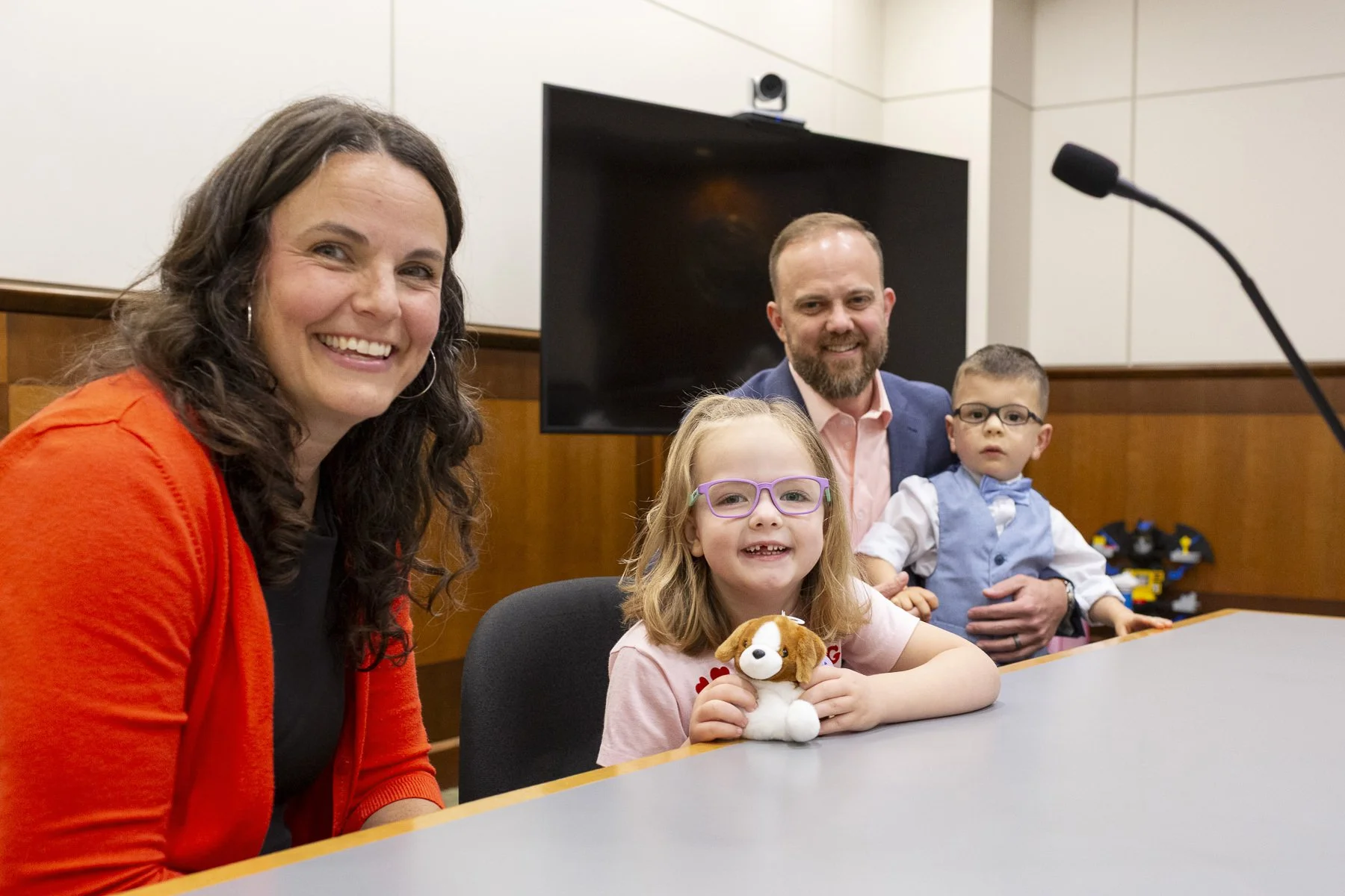 Beautiful family welcoming a child with special needs into their family at a courthouse adoption ceremony