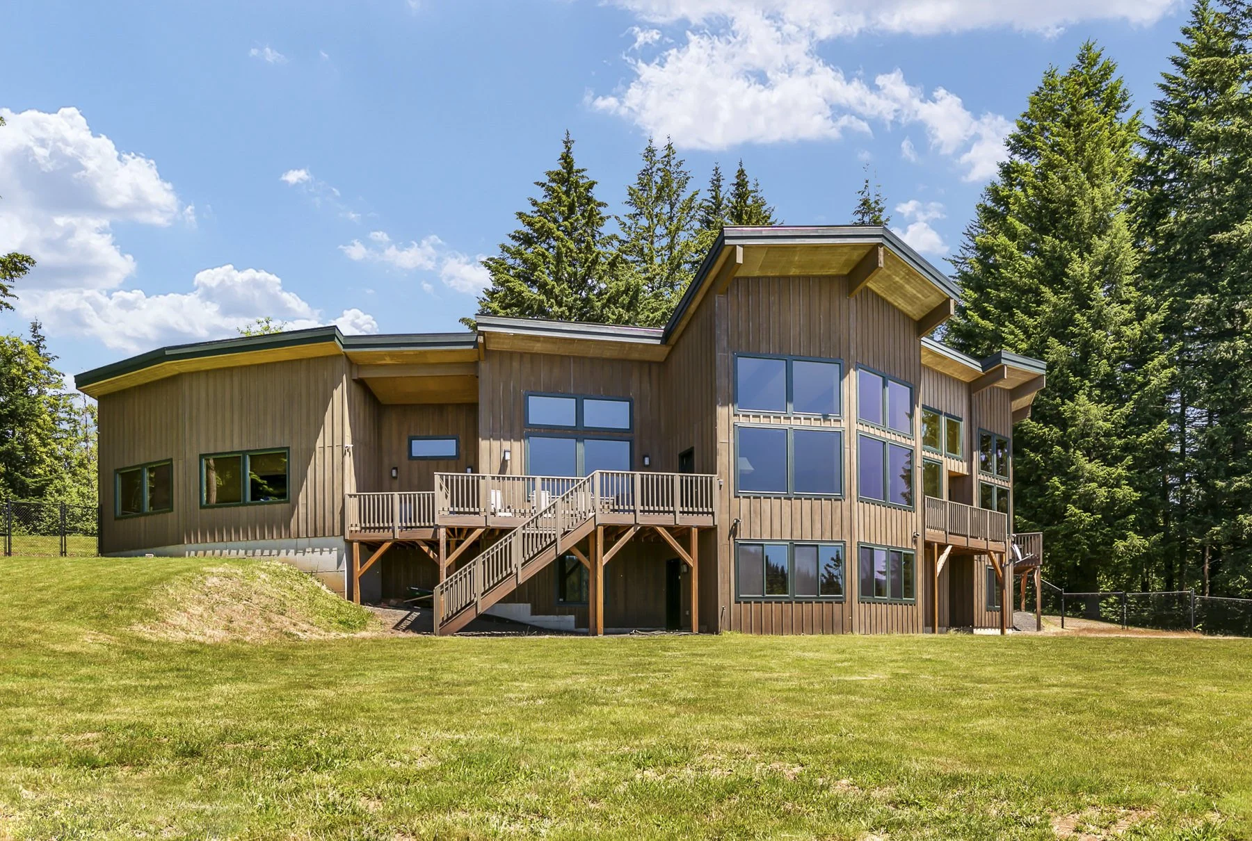 Exterior view of the back of a contemporary lodge-style home in Washougal, WA