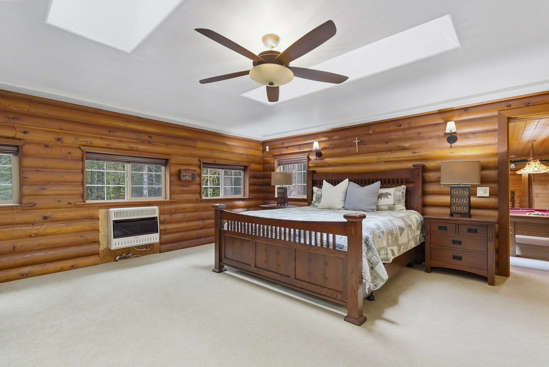 Primary bedroom in a rustic cabin in Northwoods in Cougar, WA