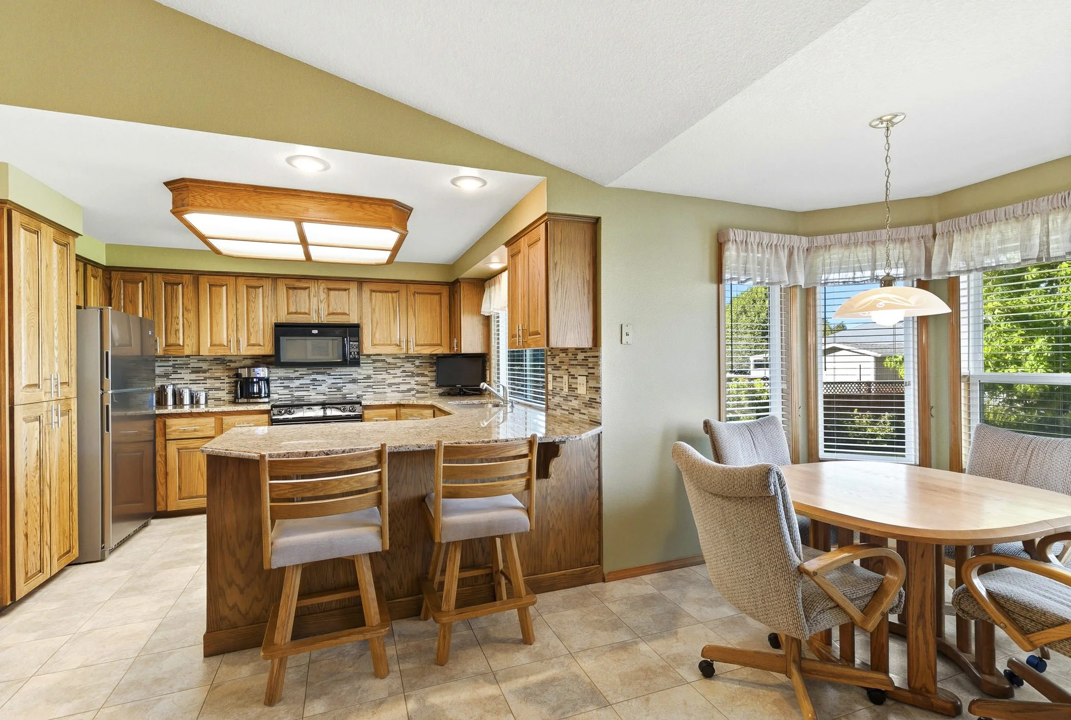 Kitchen and dining area of a home in Columbia City, OR photographed by Paul Rich Studio