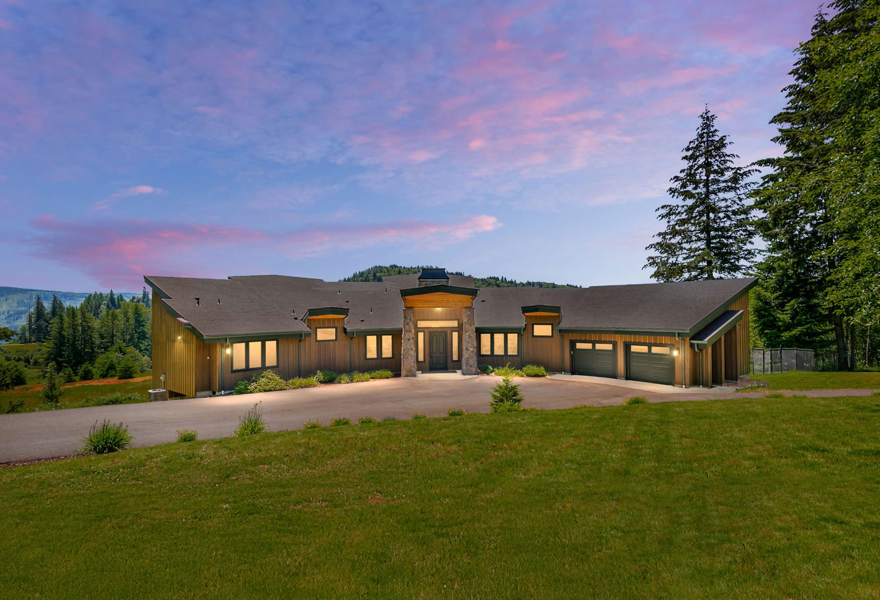 Contemporary lodge-style home in Washougal at twilight overlooking the Columbia River Gorge