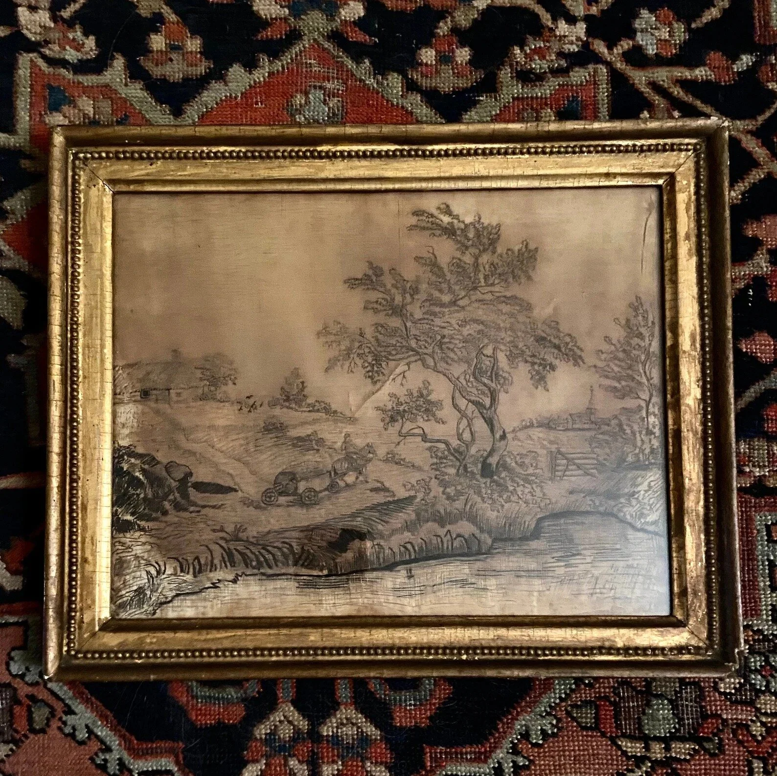 Welcome to Sunday! We are delighted to share another hair worked item with you!

This is a stunning human hair embroidery in a gilt frame. This picture is in human hair of blonde, brunette, and black hair. We see trees, a river, a fence and a church.