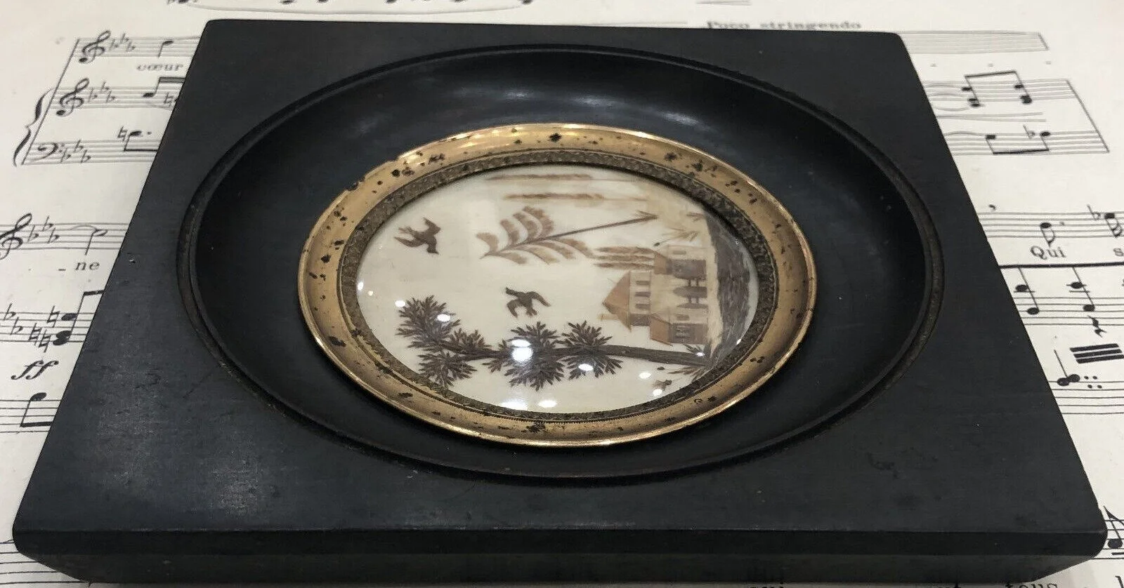 Welcome to Monday! We are delighted to share another item of antiquity with you!

  This is a framed sentimental picture made of hair that is flat worked/ pallete worked. We see cypress trees, and a fir tree in blonde hair, and another tree in dark b