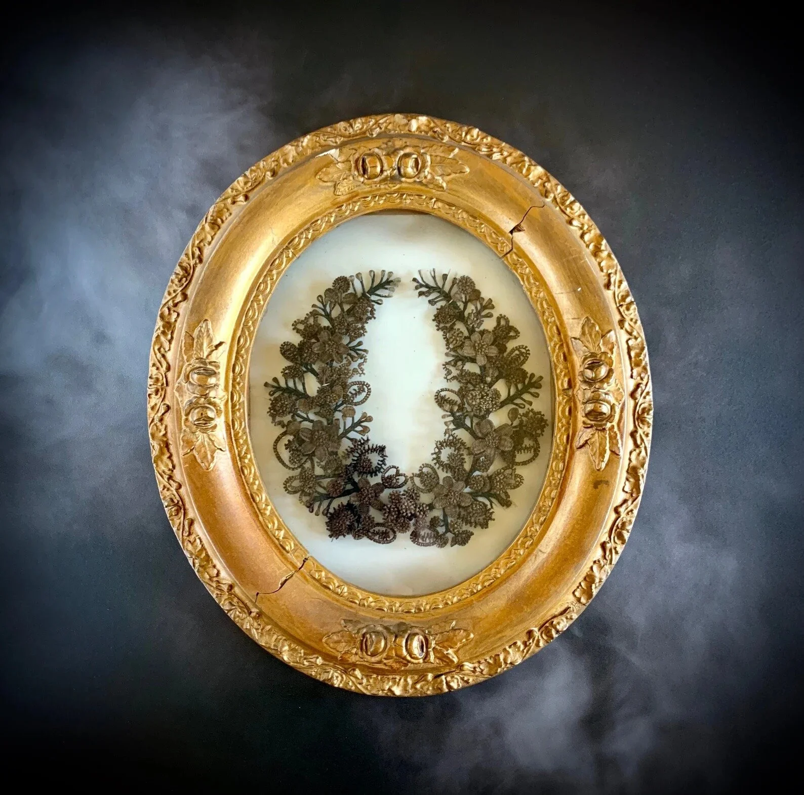 Welcome to Wednesday! We are delighted to share another item of antiquity with you.

  This is a magnificent framed hair work wreath in the horseshoe shape. The flowers are made in at least 3 hair colors if not 4. There are 4 methods used in this wre
