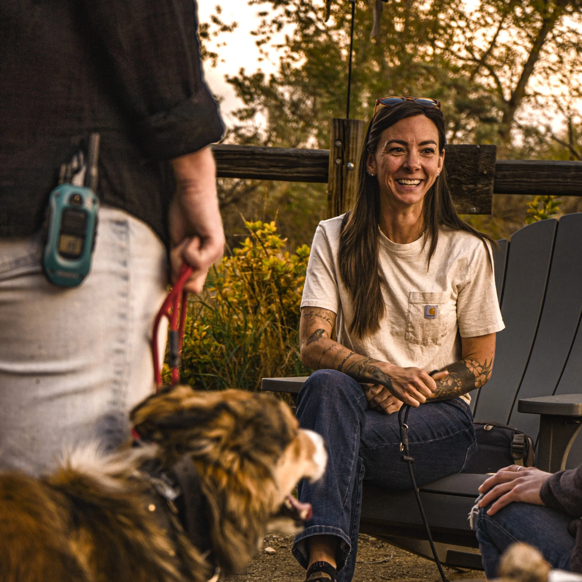 Kourtni, certified dog trainer and owner of The Actualized Canine, with clients and their dogs at a community event in Grand Junction, CO