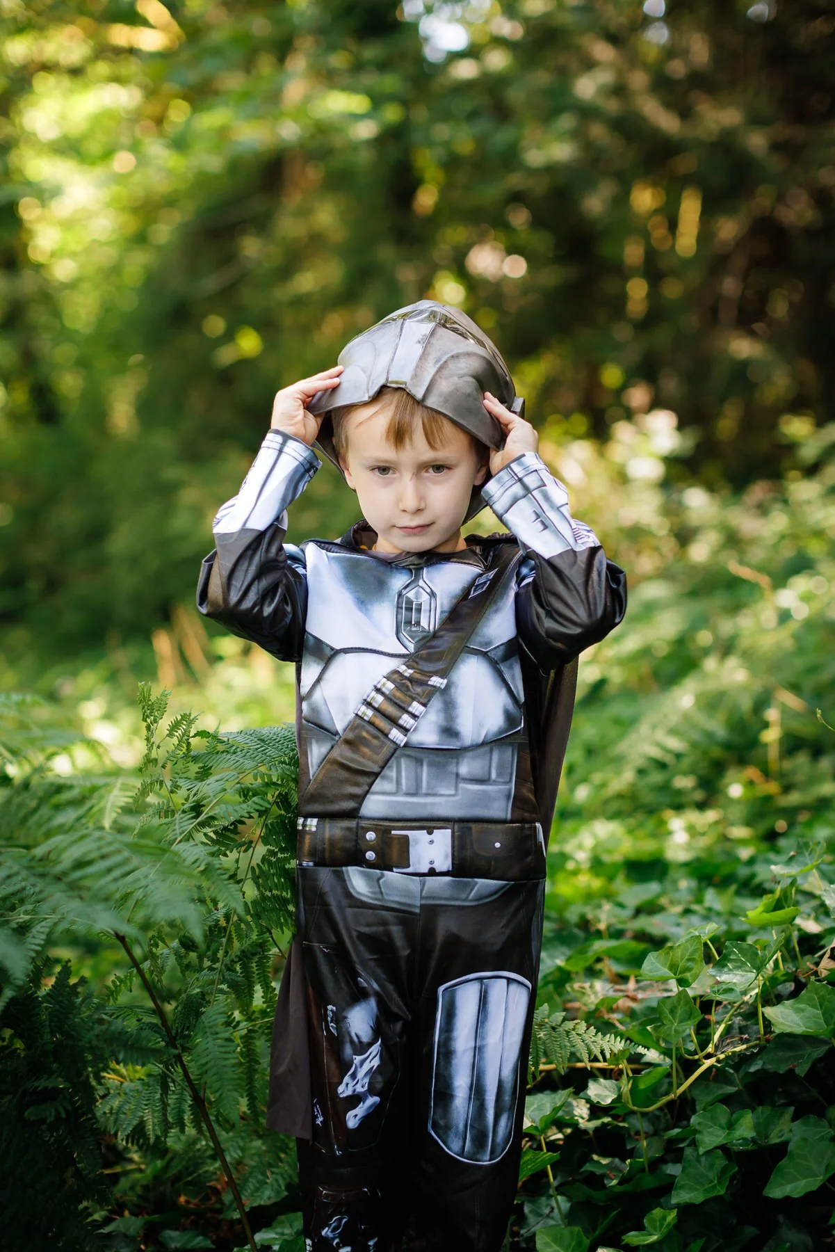 boy dressed as Mandelorian in backyard