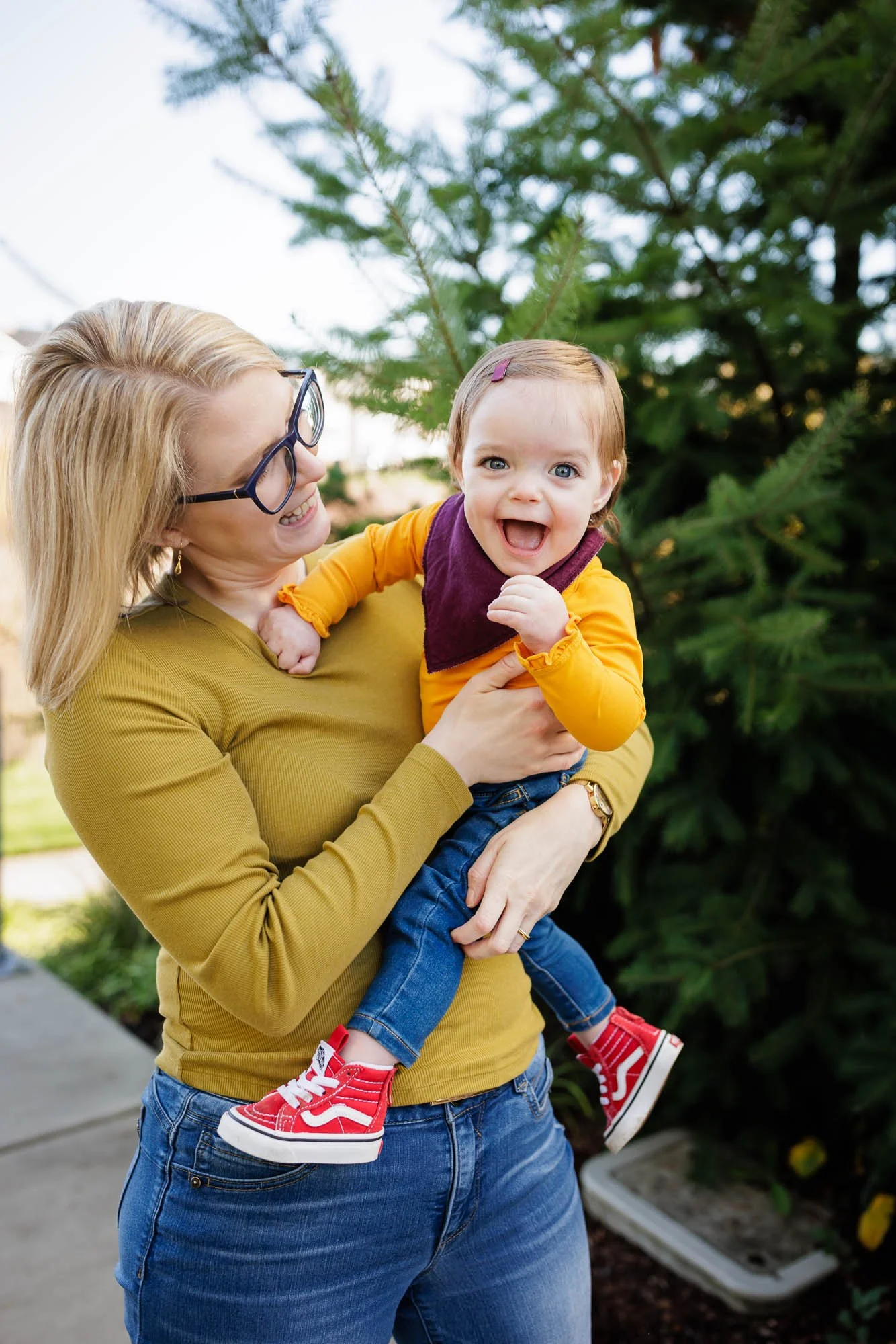 toddler laughing outside with mom