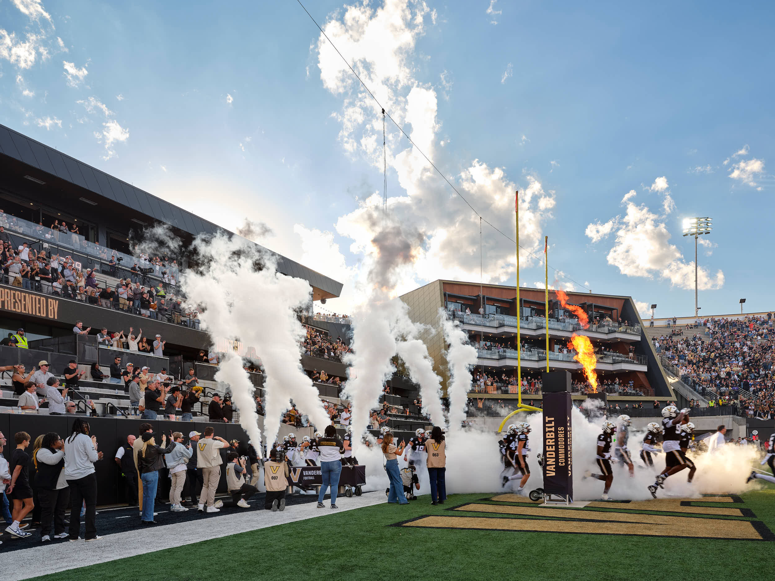Professional architectural photography of the Vanderbilt FirstBank Stadium South End Zone expansion. Highlights include the Frist Athletics Village, Commodore Suites, and modern SEC stadium design by Populous and Barton Malow